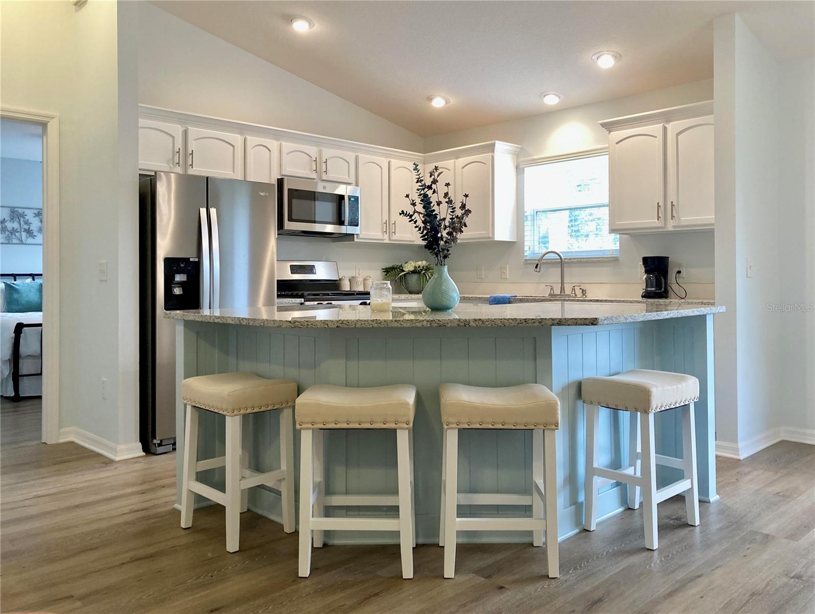GREAT LOCATION! Beautiful 3 BR/2 bath/2 car garage, Village of Amelia home about 5 MINUTES south of LAKE SUMTER LANDING - with nightly music, dancing, dining, shops, groceries, banks, medical, etc. STEPS FROM THE AMELIA ADULT POOL/rec center - walk to a pool without the hassle of pool maintenance. Half a mile south, the Odell Rec Center has a family pool, pickleball, billiards, bocce, exercise, dance, fencing, clubs, horseshoes, cards, tennis, shuffleboard, & more! This TOTALLY REMODELED home is surrounded by golf...Bacall & Bogart Executive and Havana & Mallory Hill Championship Golf Courses - enjoy the beautiful drive home. 1 mile from the Mallory Hill Country Club & Restaurant! VERY LARGE LOT - NO NEIGHBORS DIRECTLY BEHIND! Gorgeous coastal kitchen, cabinets with pull-outs, garbage disposal, stainless steel appliances (gas stove), new granite countertops, shiplap accents. Huge island - more workspace, storage & seating. Window above the kitchen sink. Vaulted living/kitchen areas gives an open, airy feeling. Primary Suite has very large walk-in closet, ENSUITE with shower & linen closet, window in the master bath lets in natural light. Both guest bedrooms have closets & share a low-maintenance bathroom with a shower/tub combo & TWO more linen closets. Close the pocket door to create a second private suite. Updated ceiling fans with light kits, lighting, and LUXURY VINYL PLANK FLOORING throughout the entire home with NO TRANSITIONS STRIPS! Spacious inside laundry with Maytag washer / dryer included, lots of storage & utility sink. . Hand trowelled ceilings, newer modern blinds on all windows. Fresh exterior updates: new exterior lighting, new shutter paint, trimmed landscaping. Screened front porch. Relax on your screened rear lanai, with ceiling fan & extra patio slab perfect for grilling. Privacy hedges behind ROOF REPLACED (5/2023), HVAC (2019/2023), NEW gas water heater! Furniture available! Low bond! Property Inspected for Termites: June 2025! Lower Sumter County Taxes! Enjoy The Villages lifestyle with so many amenities for you: golf, shopping, dining, clubs, live entertainment, medical services & more, all accessible by golf cart. Don't miss your chance to own this upgraded home in the center of it all!
