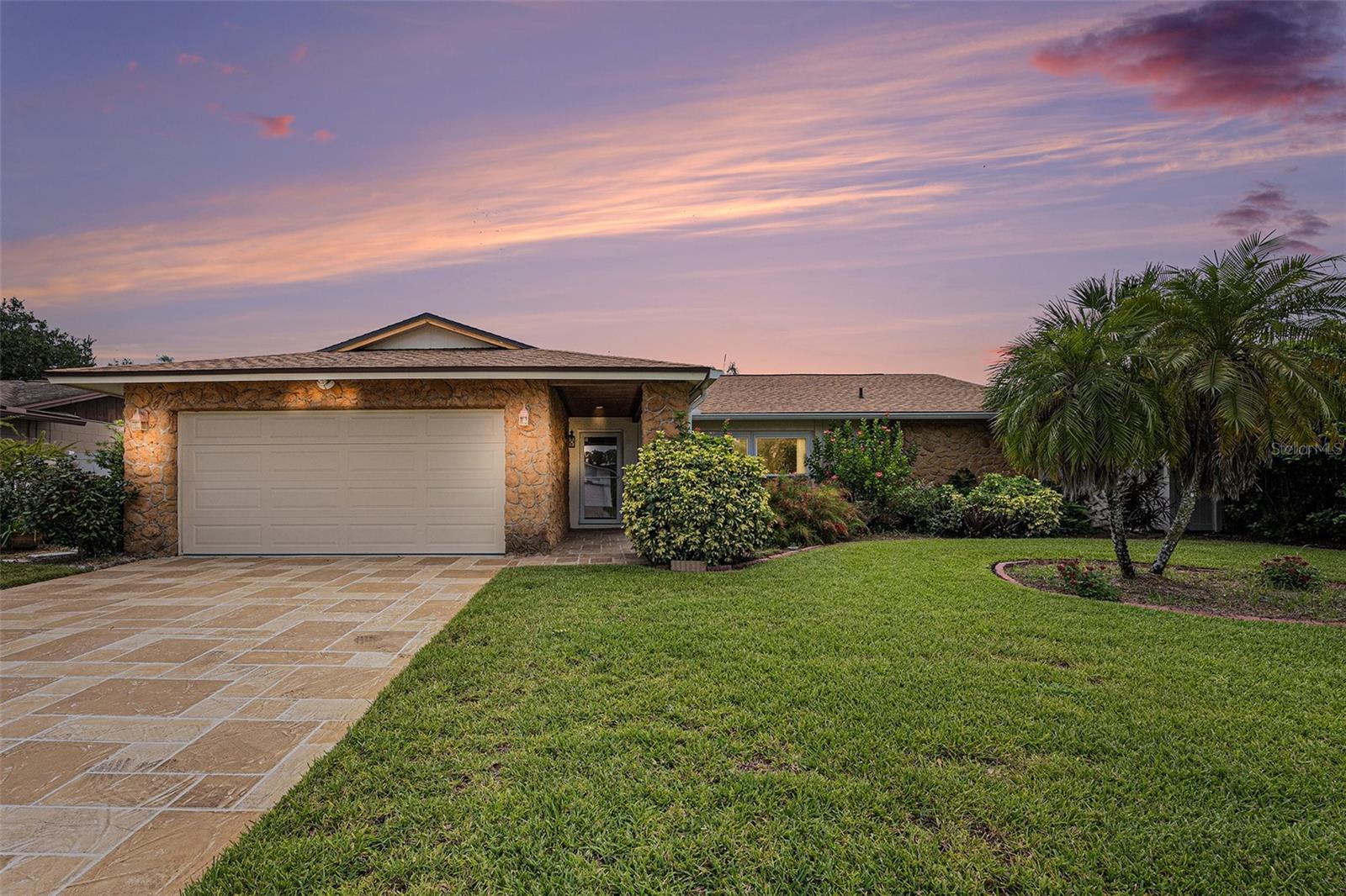 One or more photo(s) has been virtually staged. Welcome to this Carrollwood Meadows stunner! Located on a quiet cul-de-sac street, this home is the perfect choice for someone that wants a move-in ready home! BRAND NEW ROOF JUST INSTALLED, A/C SYSTEM with UV LIGHT in 2022, NEW IMPACT RATED WINDOWS AND GARAGE DOOR TOO! The kitchen and baths were recently remodeled & the entire interior has been freshly painted. This fabulous home is ready for a new family and boasts a prime location in the Carrollwood area featuring hardwood & tile flooring, formal living & dining areas along with a spacious family room that shares space with your fantastic OPEN CONCEPT kitchen boasting 42" cabinets with soft close drawers, granite counters and backsplash, large island with stylish pendant lighting and newer appliances. Convenient large walk-in pantry too. The primary bedroom offers remodeled bath with walk-in shower and super cool DEN/STUDY OR 4TH BEDROOM! The additional guest rooms are spacious with one of them offering a built in MURPHY BED! The rich PLANTATION SHUTTERS THROUGHOUT the home accompany your new impact rated windows with awesome views of the backyard oasis! Large & recently resurfaced caged pool and entertainment deck make this an entertainer's delight! Privacy is easy with fully fenced yard so let the BBQ's begin! The NEWER SOLAR PANELS WERE REMOVED TO INSTALL THE NEW ROOF AND IT'S THE BUYER'S CHOICE IF THEY'D LIKE TO REINSTALL THEM.