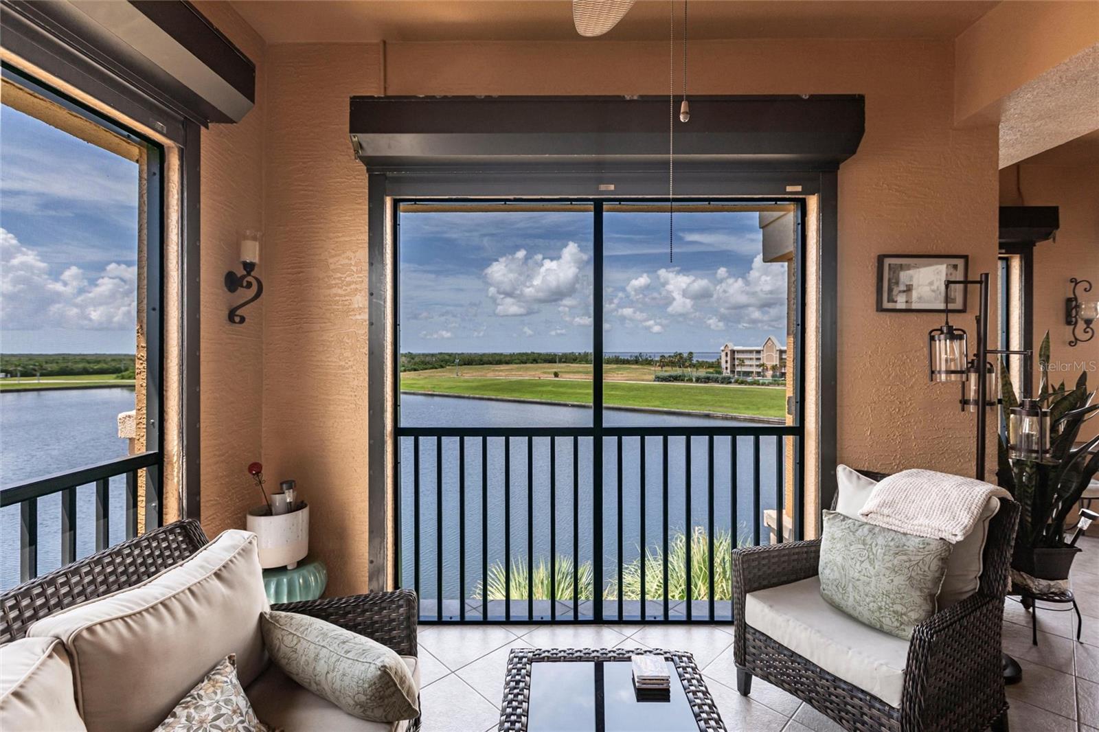 Top-Floor Corner Unit in Boca Lago at Vivante! Mediterranean-inspired condo in Punta Gorda’s premier gated, resort-style community. NO ASSESSMENTS AND COMES WITH THREE DEEDED GARAGES—a rare find! Enjoy upscale living with spacious interiors, privacy, and access to world-class amenities in a waterfront setting. This spacious and beautifully maintained top-floor corner unit offers 1,915 square feet of living space, featuring 3 bedrooms and 2 baths. Inside, the home is bright, open, and inviting, with a desirable split floor plan and three separate access points to the expansive wraparound lanai, where you’ll enjoy 180-degree waterfront views—perfect for sipping your morning coffee while taking in the serene coastal breeze. The foyer features a convenient closet and flows seamlessly into the dining area and spacious great room highlighted by tile flooring and soaring ceilings. The kitchen overlooks your great room and features, granite counter-tops, GE Profile stainless steel appliances (2022), pantry closet, raised panel wood cabinets with upper crown molding, accent lighting under cabinets, desk area and lovely breakfast nook. The primary bedroom invites you to relax and unwind with warm wood flooring (also in guest bedrooms), a ceiling fan, and dual closets, including a spacious walk-in. The en-suite bathroom offers separate his-and-her vanities, a luxurious garden tub, and a Roman-style walk-in shower with sleek frameless glass wall. The split bedroom floor plan has large guest rooms perfect for hosting out of town guests. One guest room offers walk-out access to the lanai. Guest bathroom features large walk-in shower. In 2025, the home received significant upgrades, including new impact windows, sliding glass doors, lanai screens, lanai railings, and a new roof. Additional features include three deeded garage spaces with garage door openers, a spacious laundry room with new washer/dryer (2021) and extra storage, new water heater in 2021 and electric hurricane shutters on the lanai for added peace of mind. Unit is a short walk from the clubhouse that features a fitness center, billiards room, sauna plus two in-ground heated pool, six tennis courts and so much more. Ponce De Leon Park & Peace River Wildlife center is a one mile walk away and overlooks the vast expanse of Charlotte Harbor. The parks amenities include a boat ramp, fishing piers, mangrove boardwalk, small playground, open air chapel area, and picnic pavilion. The park also has a sandy beach area that is popular for watching the sunset and the boats cruising in and out of the channel into Punta Gorda Isles canal system. Nearby to Fishermen's Village, downtown Punta Gorda shops & restaurants, great boating, fishing, sailing, and more. This home is the one. Come see it today! **PLEASE ENJOY THE 3D INTERACTIVE VIRTUAL TOUR ASSOCIATED WITH THIS LISTING**