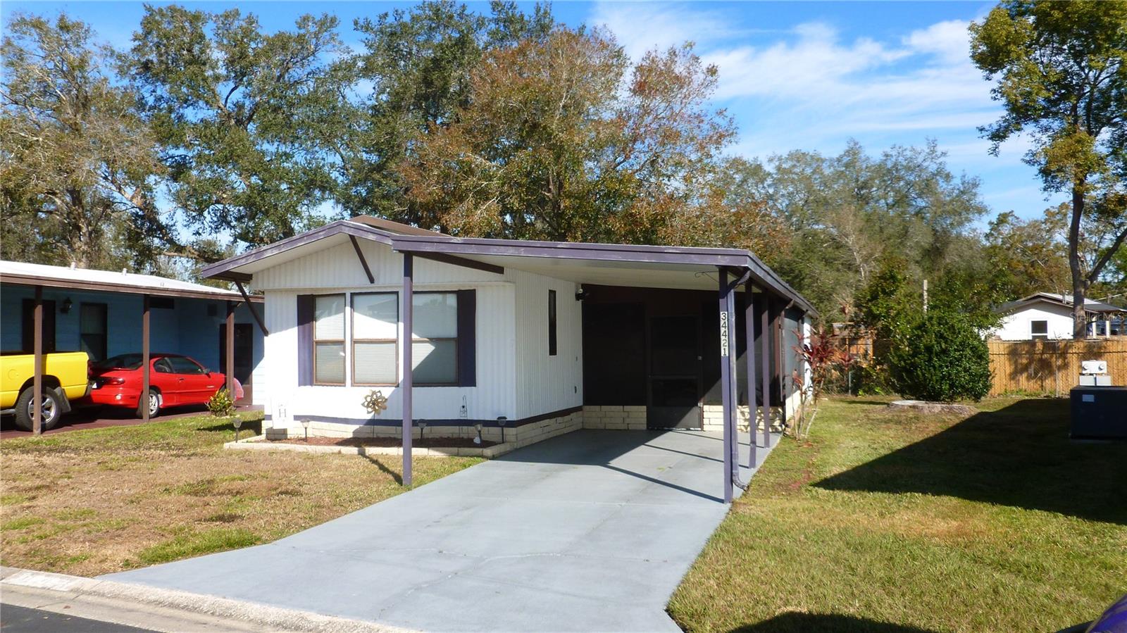 Great home for snowbirds or fulltime Florida living. Enjoy This split 2 bedroom 1-1/2 bath home with metal roof. The large entry features sliding windows and also extra refrigerator in storage is included. This home is in a great location with easy access to Wesley Chapel and Zephyrhills. All this and located in a very desirable all aged well kept family oriented community with tons of activities and great amenities some of which include 2 pools, 2 clubhouses, Shuffleboard and basketball courts, fishing lake with dock and gated security and YOU OWN THE LAND.