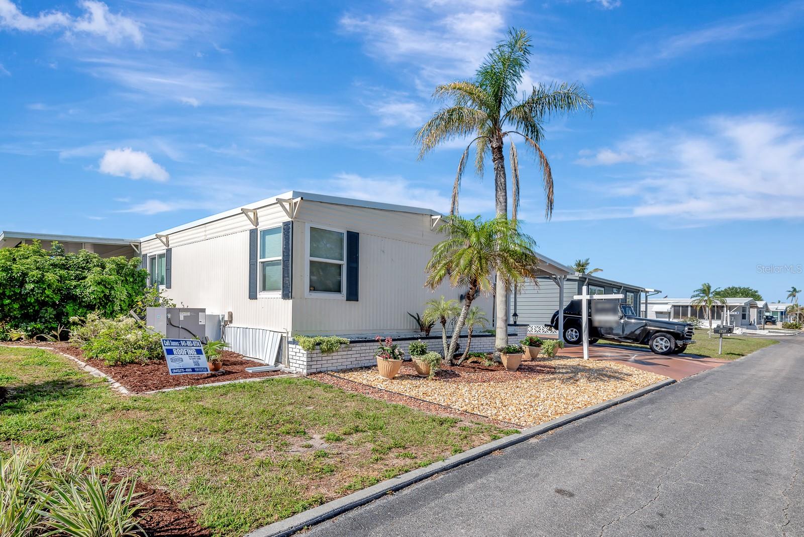 This home offers a breathtaking view of the Lake in Venice Isle. This is a meticulous 2 bedroom 2 bathroom home with a laundry room and lanai. It offers a great open floor plan. Venice Isle is just what you are looking for. This 55+ community offers two clubhouses, a fitness center, 2 tennis courts, a putting green, bocce ball, 2 heated swimming pools, a hot tub, a sauna, miniature golf, tv lounges, a ceramic kiln, a card room, 2 ballrooms, and a Sunday Service weekly. This is a very active community with almost 1,000 homes. Many of the homeowners get around the park by golf cart. The owners of this property will be including the golf cart that is on the property in the purchase price. This home has been recently updated to include new kitchen cabinets, lighting, a sink, a faucet, quartz countertops, and backsplash. The roof and carport have been updated. The carport is engineered to withstand hurricanes with center beams and cross buckles. The builder stated they had rebuilt 60 carports prior to Hurricane Milton, and none were damaged by the storm. The home offers a new AC as of October of 2024, along with new pavers on the driveway and a lovely sidewalk and bench for a great lake view. Home is being sold As Is and furnished.
