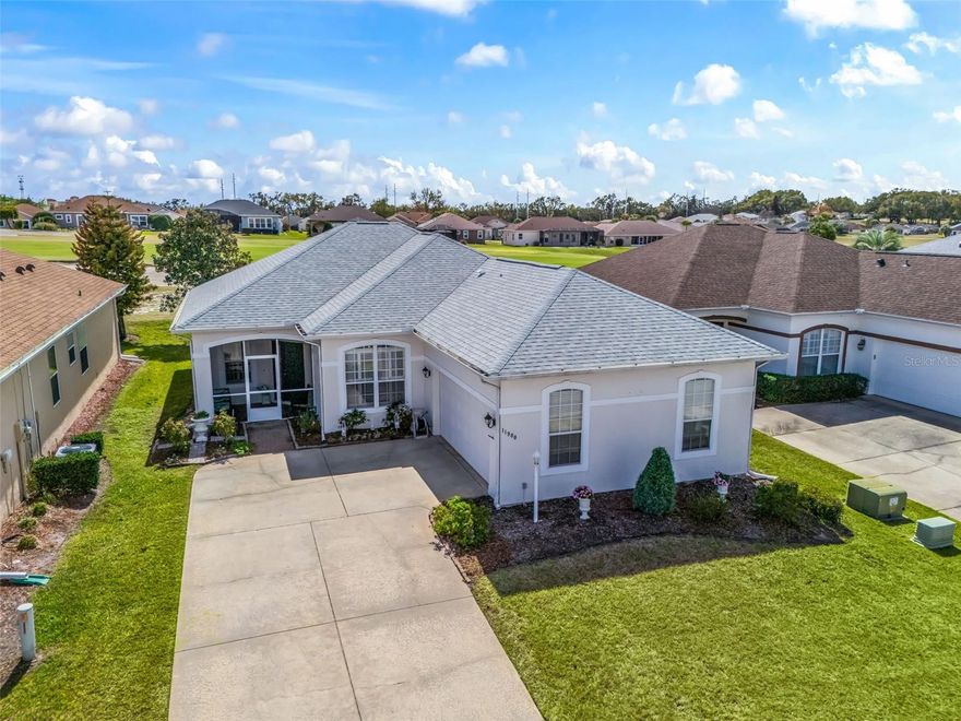 Stonecrest is a 55+ gated golf course community with all the amenities and 4 pools (one indoor), and just a Bridge Away By Golf Cart To The Villages!   This Stunning Golf Front 2/2 Custom Kingsley with a Florida Room, Bonus Room, and Side Facing 2 Car Garage, offers HVAC 2023, ROOF 2020, No Carpet, Plantation Shutters, an Open Concept Floor plan, and Tremendous Curb Appeal featuring Meticulously Maintained Low Maintenance Professional Landscaping, Screened in Front Porch, and a Front Entrance with an Elegant Door with Sidelight accent!  Upon entering into the foyer, you are greeted by Soaring 10ft ceilings, with the Dining and Living area combination creating a Huge Gathering Area, perfect for Entertaining Family and Friends!  The Dining area boasts an a Gorgeous Upgraded Chandelier, and Plantation Shutters, while the Living area is accented by the Exceptional Golf Course View, and offers access to the Family room.  The Large Open Kitchen showcases Quartz Countertops, Subway Tile Backsplash, Stainless Appliances, 42" Solid Wood Cabinetry, Pantry closet, Breakfast Bar, and Eat in Area. The Luxurious Primary Suite provides Glowing Laminate flooring, Large Walk in Closet, and a Remodeled En Suite bathroom. The En Suite bathroom has been Updated, and boasts a Double Sink Granite Topped Vanity, Linen Closet, Soaking Tub, and a Tiled Roman Walk in Shower.  The Second Bedroom features a nice size Built in Closet, and  Laminate flooring. The Sitting area(no closet) boasts Laminate flooring, Plantation Shutters, and can be used as a Bonus room or Reading area, offering additional living space, and  plenty convenience for your guests! The Remodeled Guest bathroom showcasing a New Tiled Walk in Shower with Wheelchair access!  Enjoy Your Own Private Paradise in the Florida room with an Exceptional Golf Front View! The 15 x 12 Florida room features Laminate  flooring, and creates a Fantastic space, perfect for Enjoying Additional Entertaining Area, a lovely setting for Dining, and the perfect spot for viewing Beautiful Florida Sunsets over the Golf Course! You will love having plenty of room for storage in the Side Facing 2 Car Garage with Door Opener, and Additional Storage.  $288.00 monthly HOA includes:  HOA Fee Includes: Mowing, Trimming, Outside Pest Control and Lawn Fertilization.  Stonecrest is a 55+ gated golf course community with all the amenities, pools, pickleball courts, softball, 18 hole championship golf course, Broad Stripes Golf & Social Club and over 80 different clubs to join!  As a private gated golf course community, you can expect a high level of privacy and security. Overall, this home offers a combination of Tremendous Golf Course Views, Luxurious Features, a Great Location, and a Secure Community Setting with Private Roads. A WONDERFUL LIFESTYLE AWAITS YOU IN STONECREST!