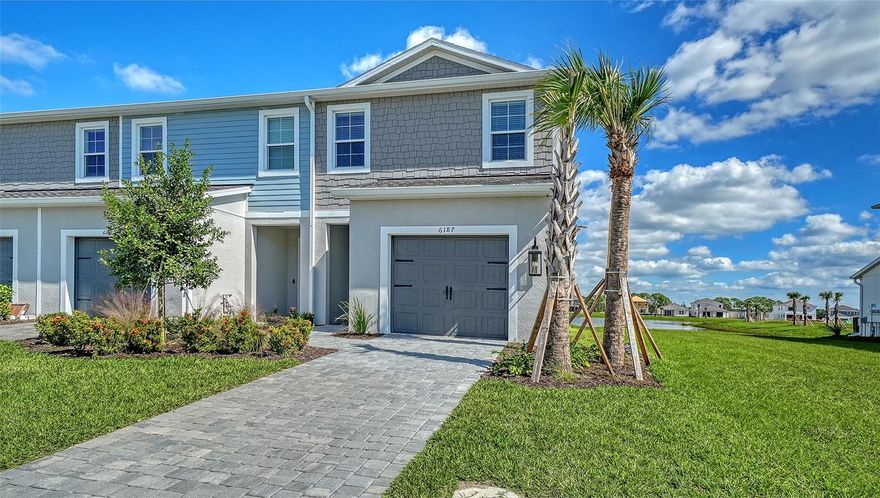 This stunning 1,790-square-foot end-unit Avery is flooded with natural light from two large south-facing windows and an 8-foot triple sliding glass door overlooking the serene Grand Park pond.  The nearly 20’ wide great room at the rear of the home provides an open, airy space perfect for relaxing or entertaining.  Enjoy abundant storage with the convenience of a spacious garage, pantry under the stairs, large lanai closet, and a full laundry room. With three bedrooms, there’s plenty of room for everyone.  Residents enjoy full access to Grand Park’s extensive amenities, trails, and lush green spaces. Don’t miss this rare end-unit opportunity!