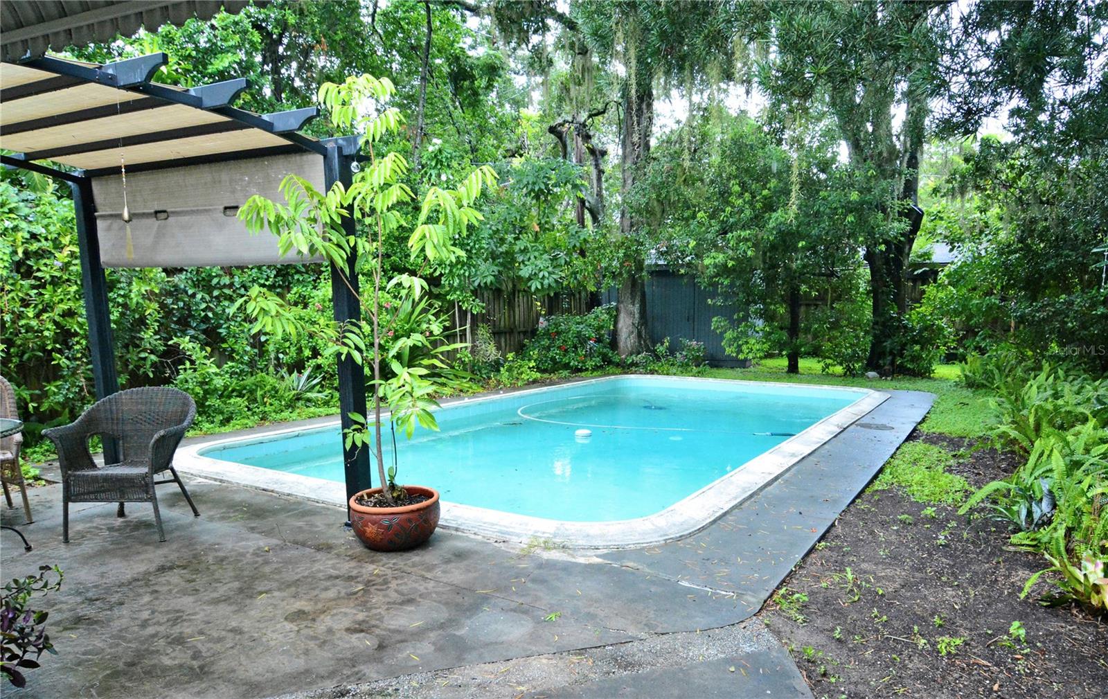 This mid-century modern home has been lovingly upgraded and maintained with renovations that make it completely move in ready, while leaving room for the new family to make it their own. It is a 3-bedroom, 2 bath pool home, 1524 sq ft, on a quarter of an acre lot, featuring a backyard that is a truly beautiful sanctuary, creating a feeling that you are in the middle of a tropical oasis. All while being within walking distance to shopping, restaurants and a short distance to all of the Orange Ave hospitals and downtown Orlando. No HOA!
This home is within blocks to beautiful Wadeview Park and highly rated schools, Blankner, which is K through 8th, and sought after, Boone High School. A short walk or drive to Freshfield Farms for meats and produce, Publix, and restaurants for convenience and lifestyle, while still feeling private and off the main road.
This location is absolutely amazing, with I-4, the 408 and the airport so close and theme parks just a short drive away, true city living, with a property that makes you forget to how close you are to everything!
You enter the house into a large cathedral ceiling living room with lots of windows and light.
The kitchen has been opened up, and new cabinet doors and countertops have brought new life to the space, a spacious storage/laundry area, complete with new washer/dryer, is off the kitchen with access to the backyard.
One of the most remarkable features is the pristine terrazzo floors throughout the house, that have been well taken care of by the current owners. I rarely see terrazzo in this amazing condition and they keep the home cooler, with an ease when it comes to maintenance.
Roof is only 10 years old on the main house, and the carport roof is less than a year old.
The present owners did a lot of upgrades. Among them are, new drain field installed 10 years old, high-end thermopane windows, tankless gas water heater, and gas kitchen stove. A whole house water filtration system, new paint, interior and exterior. Both bathrooms have been refreshed with new cabinetry, yet the mid-century aesthetic and integrity have been kept as well, creating the best of both worlds.
The backyard is large and so serene, fully enclosed with 8 ft wooden fences, the back corner of the yard houses a good size shed lined with shelves for storage. And the large, gorgeous pool, stunning trees, natural Florida landscaping, and the fire area, will provide so much opportunity for you and family to connect with all that nature has to offer, right in your own backyard! It truly must be seen and felt to be fully appreciated.
On the side of the backyard, with a convenient door into the laundry/storage area, there is an area of raised beds ideal for permaculture lovers to grow an edible garden. The front yard has 2 mature mango trees (and they are delicious!) and more.
This home is truly a treasure, so don't miss an opportunity to view this home and make it your own!