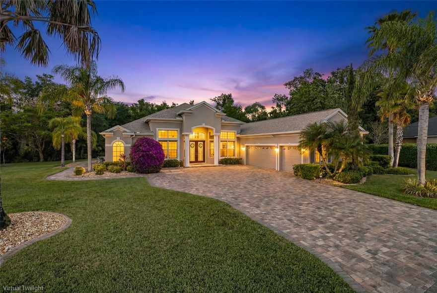 Nestled behind the coveted gates of Magnolia Estates, this magnificent 4 bedroom, 3 full bath, 1 half bath pool home with private office is perfectly positioned on a breathtaking 1/2 acre conservation homesite offering exceptional privacy and tranquil natural views. From the moment you arrive, the expansive driveway, lush tropical landscaping, and impressive curb appeal set the stage for what awaits inside this meticulously maintained residence. Designed with an open floor plan that lives large, this stunning home seamlessly blends elegance, comfort, and functionality. Soaring ceilings and beautiful tile flooring welcome you into the formal living and dining areas, creating the perfect backdrop for entertaining and everyday living alike. At the heart of the home, the chef-inspired kitchen is sure to impress with rich wood cabinetry, gleaming granite countertops, double ovens, cooktop, and abundant prep and storage space ideal for hosting gatherings both large and small.
The spacious family room is warm and inviting, showcasing a custom-built entertainment wall complete with an electric fireplace, creating the perfect place to relax and unwind. Privately tucked away, the luxurious primary suite offers two closets and a spa-like en suite bath featuring dual vanities, a relaxing garden tub, and separate walk-in shower. Bedrooms 2 and 3 are generously sized with newer carpeting and share a well-appointed guest bath, while the 4th bedroom is ideally situated at the rear of the home with its own private bath that also serves as a convenient pool bath. A dedicated office, half bath and oversized laundry room complete this thoughtfully designed floor plan.
Step outside to your own private Florida paradise. The sprawling screened lanai features a sparkling swimming pool with spillover spa, ample covered and open-air entertaining space, and peaceful conservation views with no rear neighbors. Whether enjoying sunny afternoons poolside or relaxing evenings under the stars, this outdoor retreat offers the ultimate in privacy and relaxation. This exceptional home has been lovingly maintained and extensively updated with valuable improvements including a BRAND NEW ROOF (2023), new pool pump (2024), upgraded pool enclosure and re-screening (2025), new water heater (2025), new primary HVAC system (2024), garage updates including paint, flooring, and custom cabinetry (2023), new carpet (2022), replaced window screens (2025), custom family room entertainment wall and surround sound system with lanai speakers (2020), freshly sealed driveway pavers (2026), and so much more. Residents of Magnolia Estates enjoy gated privacy along with community amenities including a playground and private boat launch ~ LOW HOA fees & NO CDD fees! Conveniently located in the highly desirable Trinity area just steps from Pinellas County, this home offers easy access to shopping, dining, top-rated schools, championship golf, beautiful Gulf beaches, and is just a short drive to Tampa International Airport and St. Pete–Clearwater International Airport.