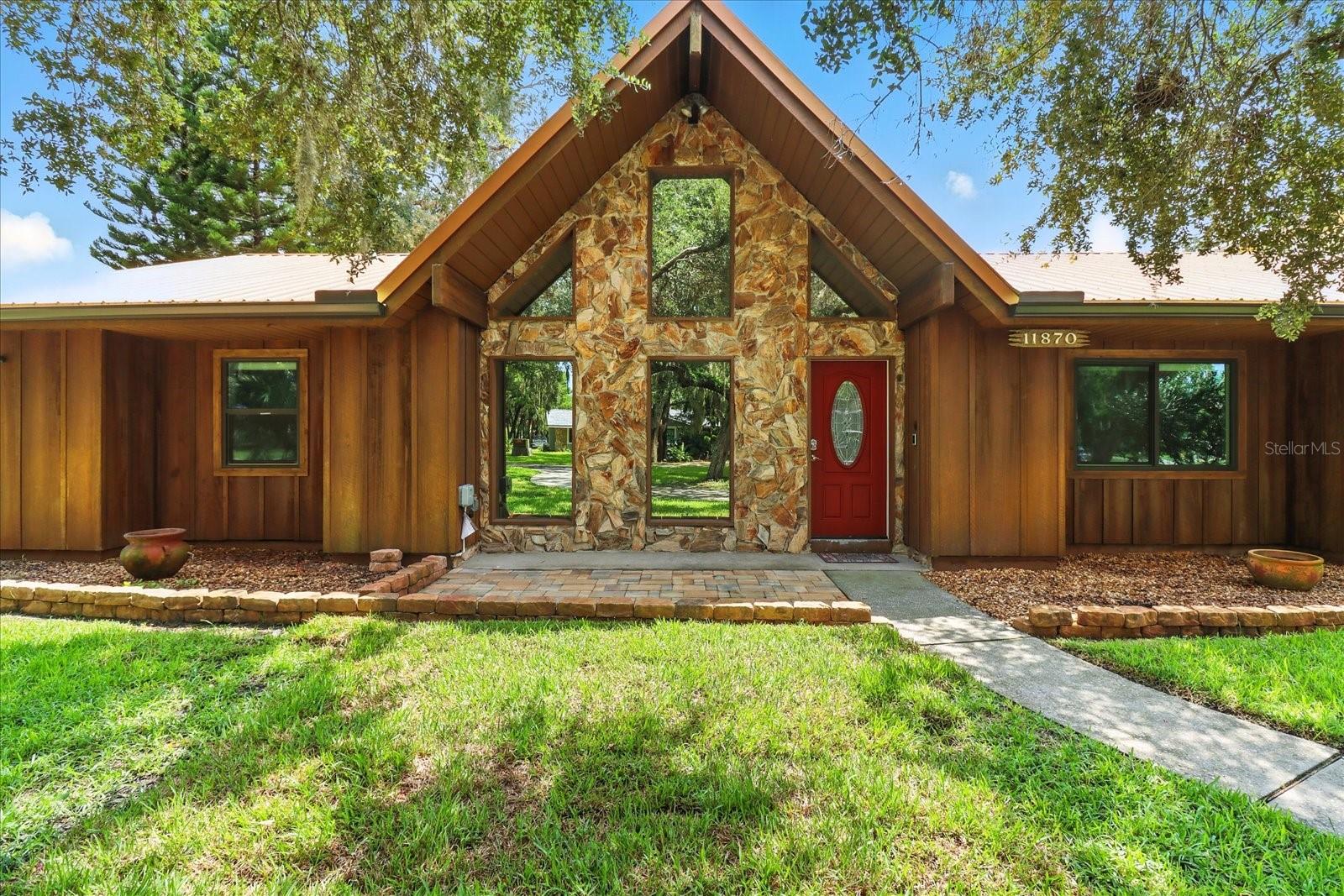 Welcome to your dream waterfront retreat in the highly sought-after River Haven Village! This beautifully updated 3-bedroom, 2-bathroom home features an office, spacious living areas, and endless amenities perfect for Florida living. Step inside to discover a bright and open layout, highlighted by a double-sided fireplace that warms both the large living room and cozy family/game room. The completely renovated kitchen boasts solid surface countertops, stylish backsplash, brand-new appliances, and a convenient eat-in space. You’ll also love the instant hot water heater and oversized laundry room with built-in cabinets. Every detail has been thoughtfully updated—from the durable tile floors throughout to the metal roof that ensures peace of mind for years to come. Outdoor living shines with expansive wood decking, two gazebos for shade, and a chain-link fenced backyard perfect for pets or play. For the boating enthusiast, enjoy your own private dock, covered boat slip with lift, and direct Gulf access for unforgettable days on the water. Bonus features include a 22’ x 32’ detached garage for all your storage needs and a gas generac generator. Move-in ready and made for coastal living — come see it