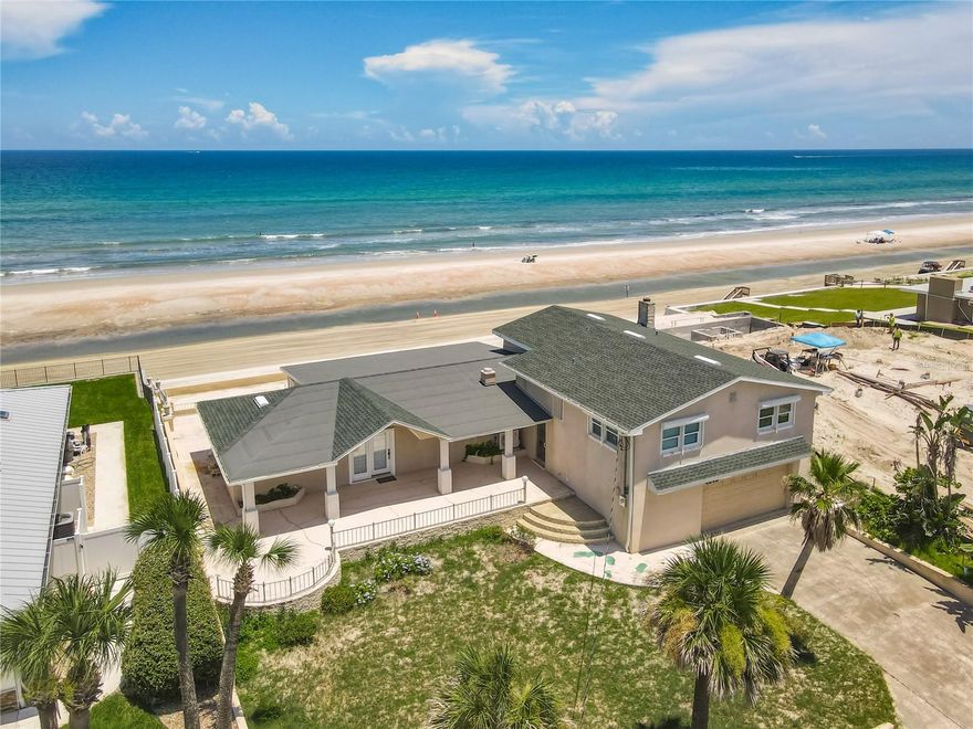 Awe-Inspiring Oceanfront Opportunity! Perched on a spectacular 75-foot-wide stretch of direct oceanfront, this property offers a rare chance to own a slice of paradise on one of the most awe-inspiring coastlines in Florida. With 188 feet of depth and over 3,200 sq ft of interior space, this unique multi-level home blends mid-century charm with a warm 1986 addition—designed to embrace panoramic ocean views and seamless indoor-outdoor living. Inside, the flexible split-level floor plan includes 4 true bedrooms, 3 full baths, and 2 additional bonus rooms—each with en-suite baths—providing ideal flexibility for guest suites, a home office, or an in-law setup. On the main level, a welcoming beach suite features durable Chattahoochee stone flooring, perfect for sandy feet, and opens via French doors to one of three expansive oceanfront terraces. This suite also includes a full en-suite bath, offering a convenient retreat for beachgoers or overnight guests. A wall of windows in the adjacent family room captures unobstructed ocean views, with more French doors bringing the outside in. Half walls create natural flow between the family room, living room, dining area, and a spacious bonus recreation area.  The galley-style kitchen is efficient yet inviting, featuring a breakfast bar that opens directly to the dining area - ideal for casual meals while enjoying views of the Atlantic. A split staircase leads to the upper bedroom level, where the oceanfront primary suite impresses with wood floors, a wall of windows, walk-in closets, and a private en-suite bath. Bedroom 2 has direct access to a full bath that also opens to the hallway for guest use. Bedroom 3 opens to the hall and shares that nearby bath. Bedroom 4, more modest in size, features its own private door to a third bath that also connects to the hall - perfect for flexible family or guest arrangements. The lower level houses an oversized 720 sq ft two-car garage and a 400+ sq ft recreation room with a fireplace and attached bath - an ideal space for a future guest suite, in-law quarters, or creative use. An extra-wide driveway and generous off-street parking pad out front offer rare beachside convenience, making entertaining effortless with room for a multitude of cars - this is an absolute commodity in this location. Outdoor living is unmatched, with a spacious 15x41 front porch and three concrete tiered oceanfront terraces offering multiple levels of entertainment space - all on a peaceful, drive-free beach. Recent updates include a new roof in 2023, partial seawall and terrace rehabilitation, and two new A/C systems - one installed in 2024 and the second just this week in 2025. While the home itself may invite your personal touch and updates, its position on one of the most incredible oceanfront lots available - complete with expansive porches, generous parking, and tiered terraces - makes it a true gem for embracing Florida's best coastal lifestyle