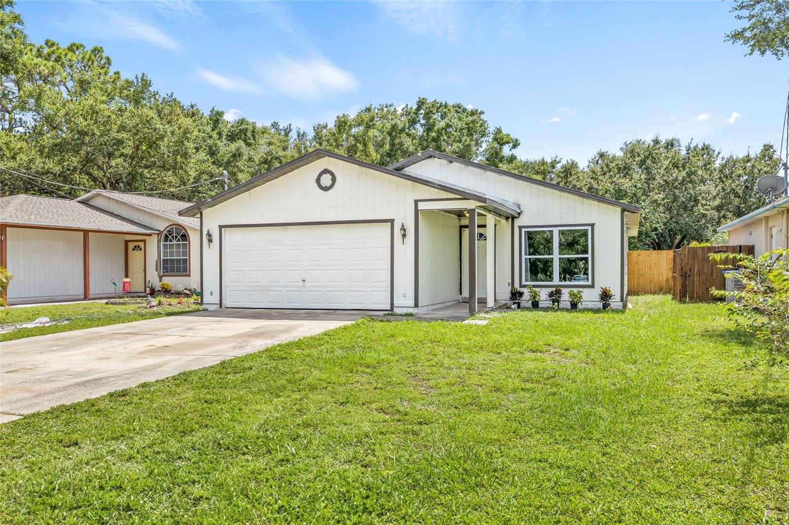 Welcome to your next home in the vibrant community of Oldsmar! This inviting 3-bedroom, 2-bathroom residence blends comfort, functionality, and a fantastic location near outdoor recreation and local favorites. As you arrive, you're greeted by a welcoming exterior that sets the tone for what’s inside. Step into the spacious living room featuring half-vaulted ceilings, creating a cozy and open feel—perfect for relaxing or enjoying a movie night. The living area flows directly into the dining space, ready to host family dinners or gatherings with friends. Down the hall, you’ll find a kitchen filled with abundant cabinetry and beautiful stone countertops, offering plenty of space for all your cooking needs. The primary bedroom is bright and airy, complete with its own ensuite bathroom for added privacy and convenience. Two additional guest bedrooms are filled with natural light and share a guest bathroom—clean and functional, ready for your personal touch. Step outside to enjoy the covered, screened-in back porch, ideal for morning coffee or relaxing in the evenings. The large, fully fenced backyard offers plenty of space for outdoor activities, gardening, pets, or even a future pool. This home also features a spacious two-car garage with washer and dryer hookups, adding both convenience and extra storage. Located near the Mobbly Bayou Wilderness Preserve and Beach Park, you'll have access to kayaking, fishing docks, playgrounds, a dog park, and even ziplining. Plus, the home is just minutes from some of Oldsmar’s best dining spots and local shops. Don’t miss your chance to own this lovely home in one of the area’s most convenient and nature-filled neighborhoods. Schedule your showing today!