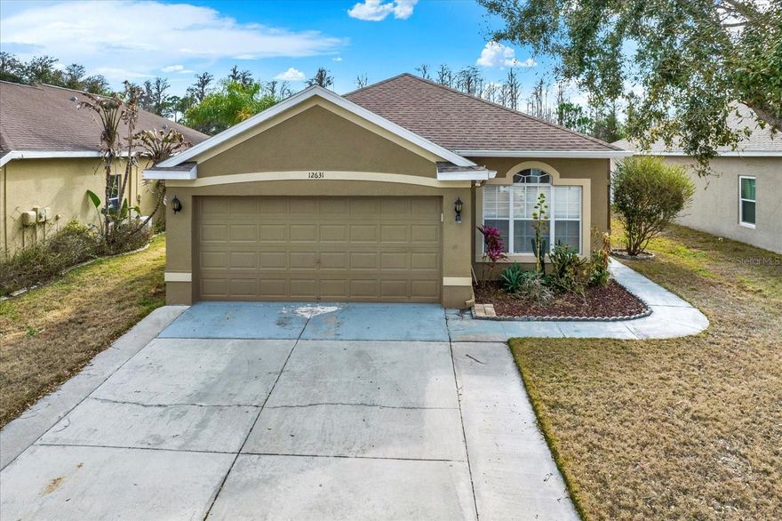 Enjoy peaceful pond views and added privacy with no rear neighbors at 12631 Chenwood Ave in Hudson. Located inside the gated community of The Verandahs, this spacious 3-bedroom, 2-bath home offers a bright, open layout with multiple living and dining areas, giving you flexibility for both everyday comfort and gathering with friends and family.

The kitchen overlooks the main living spaces, making it easy to stay connected, and features warm wood cabinetry, generous counter space, and a breakfast bar perfect for morning coffee or casual evenings at home. A separate laundry room and 2-car garage add everyday convenience.

The split-bedroom design creates a private owner’s retreat with dual sinks, a soaking tub, separate shower, and direct access to the screened lanai—an ideal spot to unwind while taking in the calming water view.

Residents enjoy a community pool, fitness center, playground, and recreation facility with kitchen, all within a pet-friendly, gated setting. Conveniently located near US-19 and FL-589, also known as the Suncoast Parkway/Veterans Expressway, offering easy access to Tampa, Trinity, Spring Hill, shopping, dining, and Gulf Coast beaches. Schedule your private showing today.