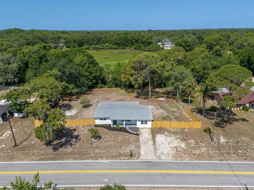 TURN KEY REMODELED HOME ON A .81 ACRE LOT WITH NO HOA & NO FLOOD ZONE! Welcome to this charming completely remodeled one story home situated on an oversized .81 acre lot. This 3-bedroom, 2-bath home offers comfortable living with 1550 square feet of interior space, making it an excellent opportunity for first-time buyers, investors, or anyone looking for an affordable home near the Gulf Coast. NO HOA. NO FLOOD ZONE. BRAND NEW IRON FILTRATION SYSTEM. NEWER AC. NEW WINDOWS. NEWER ELECTRICAL. Manicured landscaping and fresh exterior paint enhance curb appeal. Inside, the home features a functional layout with natural light throughout the living spaces. The completely remodeled kitchen features new appliances, counters and modern cabinets. A consistent luxury vinyl l flooring creates a consistent flow throughout the home. A variety of living areas provide a cozy, practical floor plan ideal for everyday living or rental potential. The primary bedroom offers privacy and a luxurious spa-like ensuite. The secondary bedrooms are comfortably sized and the fully remodeled bathroom is conveniently located to serve the home’s layout. Laundry room is air conditioned. Situated on a .81 acre lot in the established Golden Acres area, the property provides a private fenced yard with space for outdoor enjoyment, gardening, or endless possible options. A spacious lanai offers pavers with space to enjoy morning coffee or weekend BBQ’s. The location offers convenient access to local schools, downtown New Port Richey, local parks, shopping, dining, and the Gulf coastline, making it ideal for enjoying the Florida lifestyle. Whether you’re looking for a starter home, seasonal residence, or investment opportunity, this property presents great potential in a convenient location. Schedule your showing today!