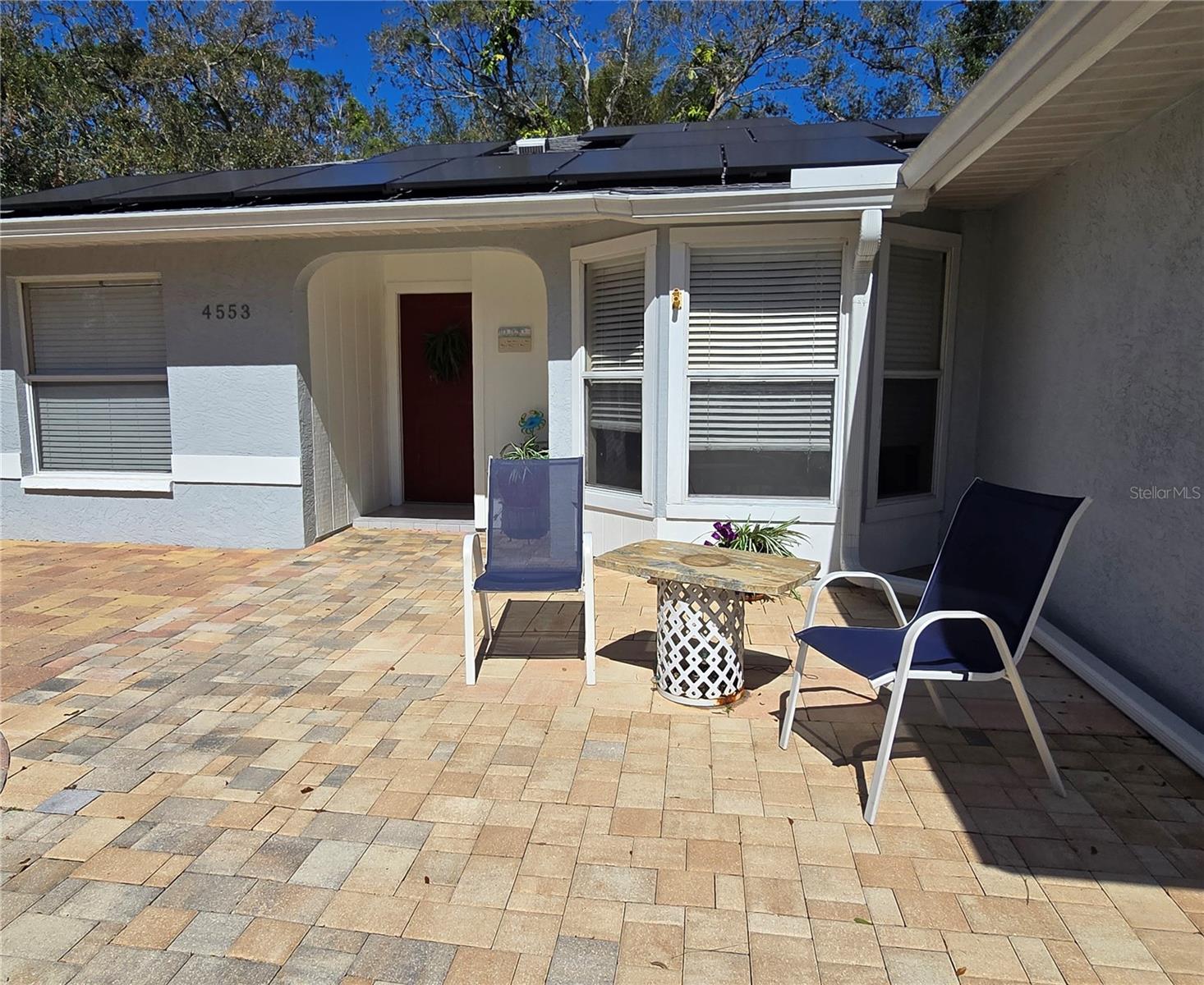 New price This property checks all the boxes. Enjoy the easy living of this three bedroom two bath split plan home with beautiful brick pavers leading to the front door. Included in the many tasteful improvements are updated bathrooms, custom walk in closet in master bath, ceiling fans, newer hot water heater and electrical panel. Kitchen has lots of natural light and a divided oven with lower convection unit. Enjoy casual dining on the screen porch which opens to expansive lighted deck with fire pit. A remote control retractable awning allows shade, making this space great for year round entertaining. This neighborhood is convenient to shopping, restaurants, public transportation, and trailhead to Legacy Trail for walking or biking. Golf courses nearby and world famous beaches. A solar assist system provides greatly reduced electric bills. Home has warranties on all systems, inspections up to date, and warranties are transferrable to new owner. This home had no storm damage and does not require flood insurance. New 2.5 ton HVAC system with 2 UV lights just installed. Full warranty.