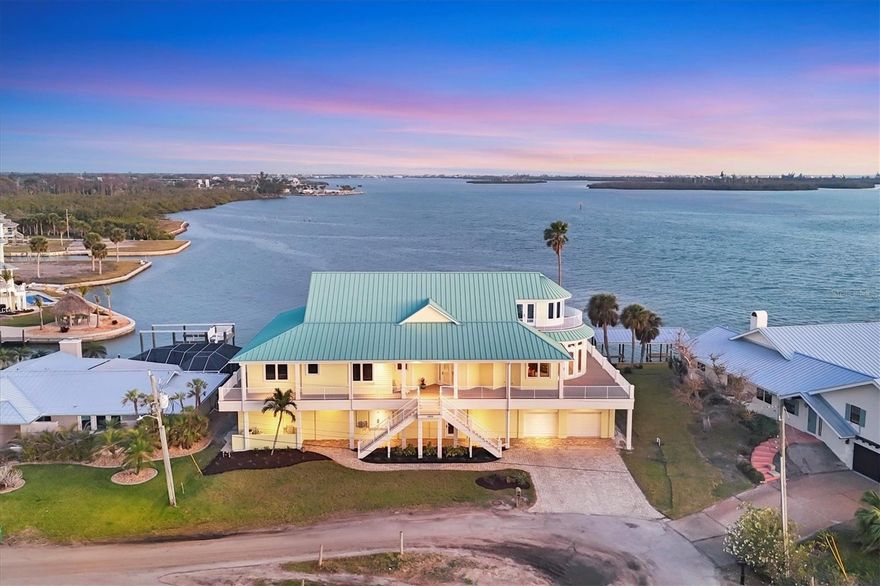 SUCH A UNIQUE PROPERTY! FOCUS on the details as this is NOT YOUR AVERAGE home with INCREDIBLE VIEWS! THE HISTORY of this property is just the beginning of the story! This 3rd generation family home provides the most AMAZING VIEWS ON THE INTERCOASTAL WATERWAY! Its unique location, lot placement and CUSTOM DESIGN offer MASSIVE WATER VIEWS from EVERY ROOM IN THIS HOME! Just wait until you SEE THE VIEWS FROM THE 3RD FLOOR with its RADIUS wall of WINDOWS! **Be sure to check out the 3-D Matterport walkthrough tour by clicking on the 'Tour 1' button at the top left of this MLS listing** This 4 BEDROOM/4.5 BATH home offers a BRAND NEW  ROOF! 3 NEW HVAC's! Mostly NEWER APPLIANCES! NEW IRRIGATION PUMP fed from private well! NEW POOL PUMPS! SALT-WATER POOL/SPA with HEATER! NEW GARAGE DOORS and openers! New exterior doors! Custom built, SOLID CHERRY cabinetry with pull-outs throughout the CHEF'S KITCHEN! GAS FIREPLACE! ELEVATOR! ROUGHED-IN and WIRED for solar! Anything that was affected by the storm surge HAS BEEN REFTIFIED! No storm is a MATCH for this INCREDIBLY STRONG, WELL BUILT, BUNKER of a home! The history here is the FOUNDATION of its beauty! The original ground-level home was built with BRIDGE SPAN-CRETE ROOF TRUSSES as a HELECOPTER LANDING PAD! Those BRIDGE TRUSSES are supported by massive concrete pilings driven so deep that the bottom of the piles could not be located during the addition project in 2008! This once eye-sore, local hangout property, has NOW BEEN ESTABLISHED as THE CORNERSTONE PROPERTY in Grove City! City water and sewer! HURRICANE SHUTTERS/IMPACT GLASS to protect ALL glass openings! Wrap-around porch with AZEK decking and columns! BRAND NEW ROOF! CORAL WRAPPED GAS FIREPLACE! One-of-a-kind RADIUS kitchen COUNTERTOP to match the RADIUS GREATROOM and 3rd floor ROOFLINES! 6-burner GAS RANGE! SOLID CHERRY spiral stair case! CUSTOM MADE CHERRY interior doors and CUSTOM MILLED interior trim! NEWLY PAINTED exterior! This home has been EXTREMELY WELL MAINTAINED and CARED FOR and NO CORNERS have been cut in the process! Speaking of corners, check out the custom corner bead/no-door-casing trim as you attend your private viewing! Such ATTENTION-TO-DETAIL IS EVIDENT everywhere! There is too much to list, but here's a few details: Starting on the ground floor, the 8'-0" CANTELEEVER ROOF overhang patio off the back of the home is unique with these massive bridge roof trusses! The POOL/SPA placement is SPECIAL to this property's history, taking the place of what was once the boat basin that intruded underneath the home! ONLY THIS BUNKER OF A HOME can handle a SITE ENGINEERING FEAT as this! The storm surge rectification began at the ground floor by installing 48" DensShield Tile Backer to replace all compromised drywall. DenShield is a lightweight, water-resistant tile backer board with a built-in moisture barrier so that a drywall replacement process won't have to be done again! All the 1st floor amenities and ground level equipment has been completely replaced/remodeled, INCLUDING THE 1st floor POOL BATHROOM! FROM THE GROUND FLOOR remodel to the BRAND NEW ROOF, this home IS LIKE BRAND NEW all over again! Roughed-in for a CENTRAL VACUUM! Security alarm! Jetted tub! 3 hvac units installed FOR TOTAL COMFORT! NEW master shower tile walls! Surround sound inside and in the pool area! Outdoor kitchen electric and plumbing roughed in! New lanai and pool screening! As you can imagine, scheduling your private showing is a must with this beauty!