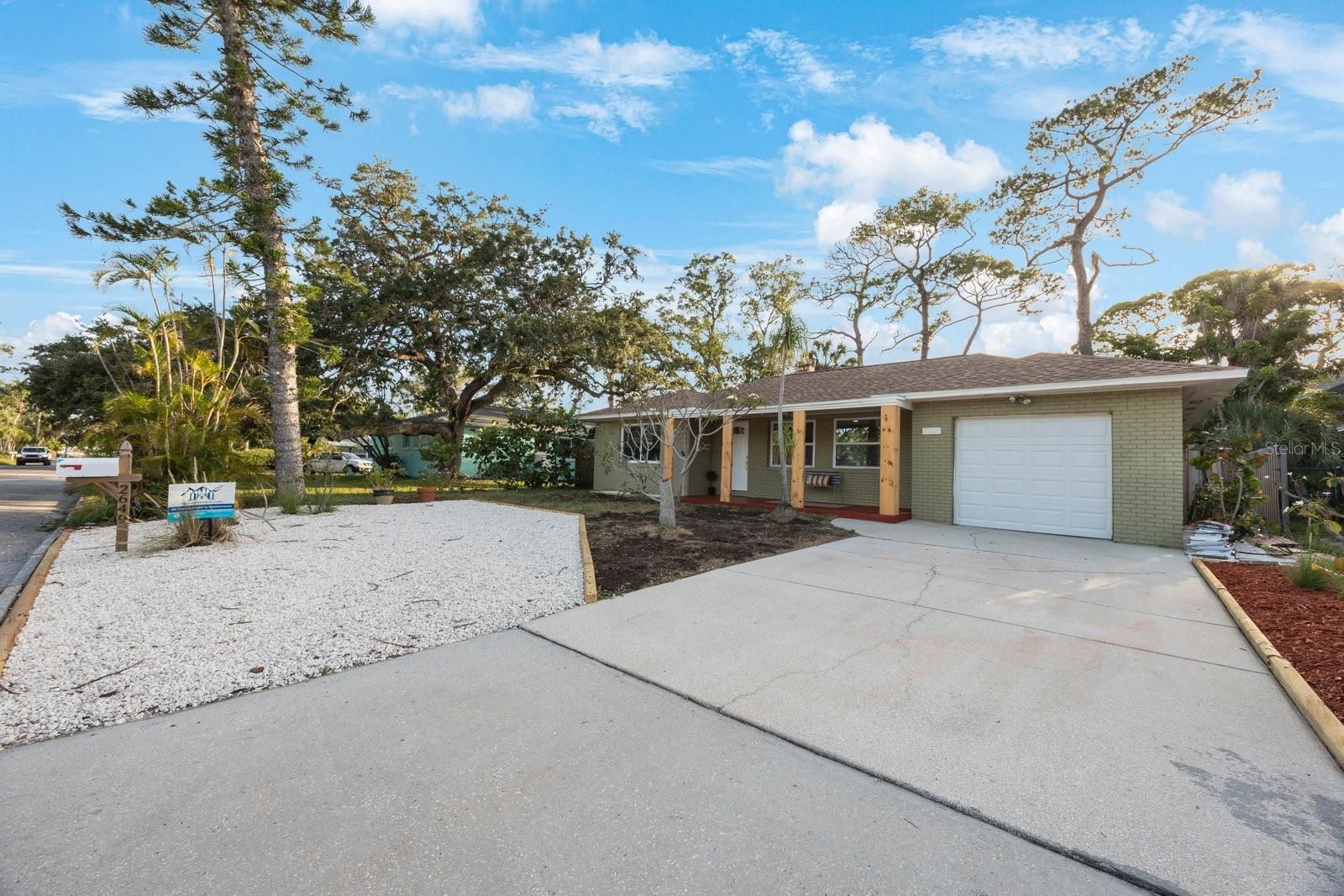 Newly Renovated Gulfport Home has just hit the market! Brand New Everything! No damage from either storm & No water intrusion inside; thanks to the step up into the home. This Two Bedroom, 1 Bath, 1-Car Garage property is move-in ready and entirely updated throughout! Walk into your bright and elegant living room space with large new impact windows & front door, as well as a fireplace with wood accent mantel. The kitchen features two-toned slow-close cabinetry with open shelving as well as a built-in wine rack & spice cabinet! Plenty of cabinet and storage space, brand new stainless steel appliances, and a window overlooking the backyard. In-home laundry area located right off of the kitchen before entering the garage area. Take notice that the owners kept the kitchen archway unique to historic gulfport designed homes, updated while keeping its integrity. Spacious bedrooms complete with closets and large windows allowing lots of natural bright lighting throughout. Step into a beautifully designed bathroom with wall to ceiling tile, brushed gold accents, mosaic shower tile, and plenty of shelving for storage & design. From the florida room step into the backyard which is prepped and ready for your vision! The raised flower beds are perfect for a vegetable or butterfly garden, the covered area can serve as a protected space to lounge or for a hot tub in the future! Two sheds for added storage and a little area for grass to grow, seed was just added to this area with the help of rainy season, the grass will pop up soon! This home exudes gulfport charm from design to landscaping; it has it all! A must see property, reach out to our agents today for a showing!