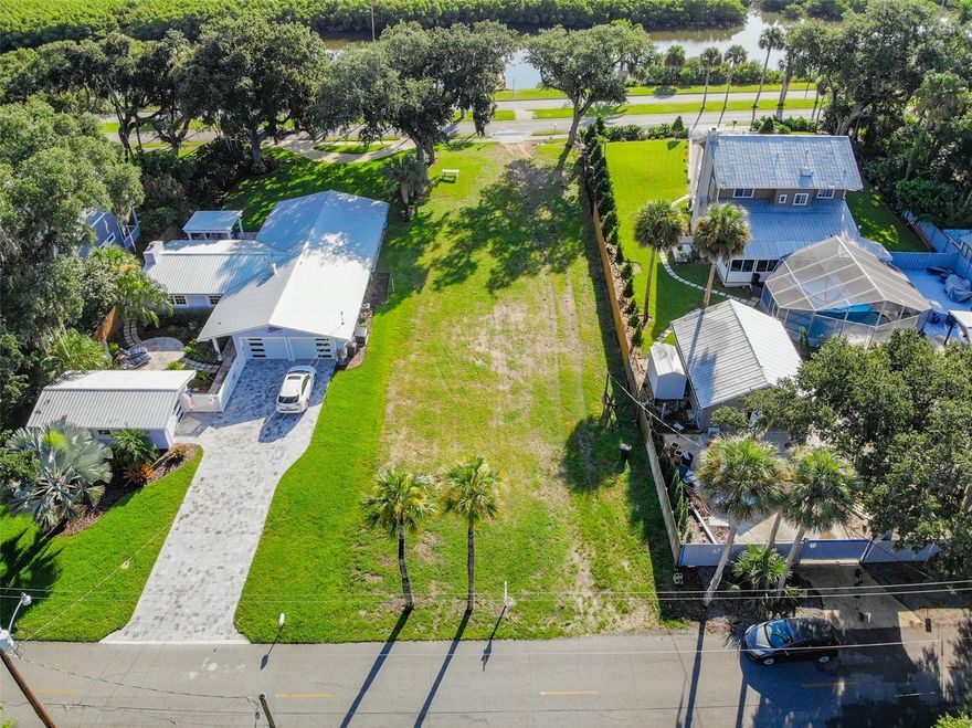 Build your dream home in New Smyrna's Garden District ~Soaring trees and Canal front property located on highly sought after North Riverside Drive. This lot has been cleared and is ready for your dream home to be built. Close to Canal Street or hop in your golf cart for a short ride beachside to enjoy all New Smyrna has to offer.  This lot spans 60 x 209 feet with access to N. Riverside and to Faulkner. NEW BOAT DOCK and LIFT has just been built with plumbing and electricity active and running at dock. Buyer to benefit impact fee credit of 3286 Sq Feet. ** All measurements and information deemed to be accurate Buyer's to verify ** A video of the property can be found on this link : https://vimeo.com/585064601/f85e28cd79 ;Water: Available at Site