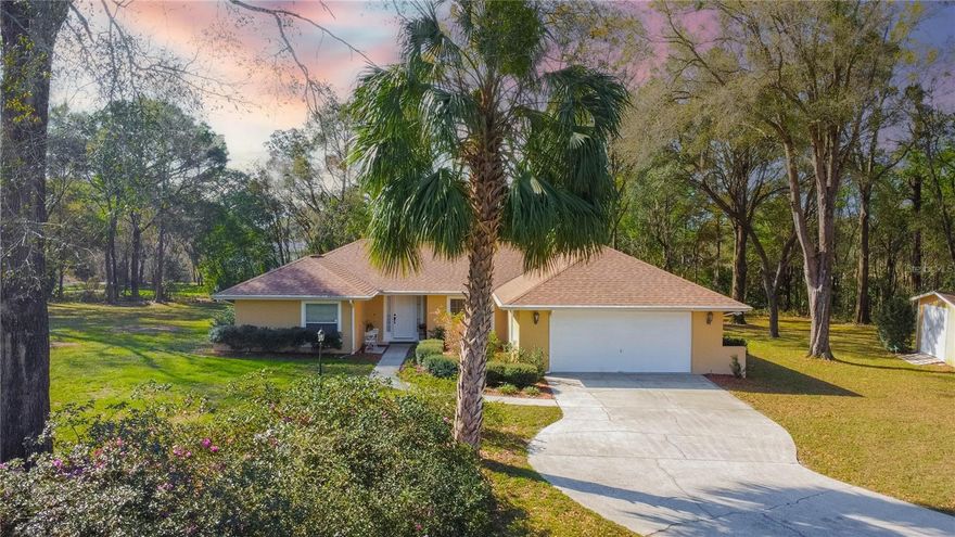 EXCEPTIONAL OPPORTUNITY to live in the beautiful, deed-restricted community of CITRUS HILLS with a $10,000 CONCESSION towards BUYER'S CLOSING COSTS! Situated on a nearly one-acre corner parcel shaded by gorgeous mature trees, this 3-bedroom, 2-bath home with 1770 living area offers privacy, space, and a lifestyle filled with amenities. The interior presents a desirable split-floor plan with an open living and dining room combination highlighted by a cozy wood-burning fireplace. The spacious primary suite includes a full bathroom and walk-in closet, guest bathroom, two spacious guest rooms, an interior laundry room complete with washer and dryer, and an eat-in kitchen with tile countertops & updated appliances. The exterior features a 2-car garage, an inground caged pool, covered lanai perfect for outdoor entertaining, and a convenient storage shed. Recent updates provide peace of mind, including a new A/C and water heater in 2024, updated Pentair pool equipment, updated appliances and updated roof in 2011. As part of the mandatory Citrus Hills Social Membership, residents enjoy access to a wide range of resort-style amenities including a community pool, dog park, lighted tennis courts, spa, racquetball, pickleball, fitness center, restaurants, scenic walking trails, and more. This property combines space, comfort, and an amenity-rich lifestyle—an excellent opportunity to enjoy everything Citrus Hills has to offer on a modest budget.