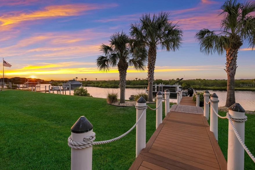 Completely renovated/updated in 2023! This is a very unique opportunity to own a boating home in a gated, golfing community! Hurricane impact windows and doors along with Flood Zone X (best flood zone code) - high & dry construction! This exceptional property presents a rare opportunity to embrace the boating and jet ski lifestyle while enjoying the convenience of being minutes away from the vibrant offerings of Lakewood Ranch just 3 miles away. Offered partially furnished on a separate bill of sale, the boat is offered on a separate bill of sale, and the jet skis are offered on a separate bill of sale. Situated in the exclusive gated enclave of 'The Islands on The Manatee River', this stunning home offers unparalleled direct access to the waterways. Boasting a private dock, lift, and river/canal frontage navigable to the Gulf of Mexico with direct access and no locke system, it's a boater's dream come true! Step inside to experience timeless Spanish Colonial elegance, with no detail spared in craftsmanship and design. Whitewashed stucco exterior, freshly painted plaster interior accent walls, wood-beamed ceilings, and dramatic fire features exude sophistication and charm. The grand foyer sets the stage for the impressive interior, leading into a breathtaking Great Room with expansive vistas through the hurricane impact windows and doors.  Entertainment awaits outdoors in the entertainer's paradise, complete with a new panoramic pool cage, an oversized heated saltwater pool, spa, gas fire pit, lounge area with TV, and a fully equipped summer kitchen. Step onto the private Trex dock, equipped with a 10,000lb boat lift, offering serene views of protected mangroves and abundant wildlife with no other homes in the distance on this coveted side of the street. Residents of this esteemed community enjoy inclusive amenities such as guard-gated entry, no CDD fees, access to the River Lodge, fitness center, putting green, clubhouse, and social events. Optional investment for Golf and Country Club access adds to the allure of this unparalleled lifestyle opportunity. Don't miss your chance to own this vision of elegance, craftsmanship, and waterfront bliss in one of Florida's most coveted locations!