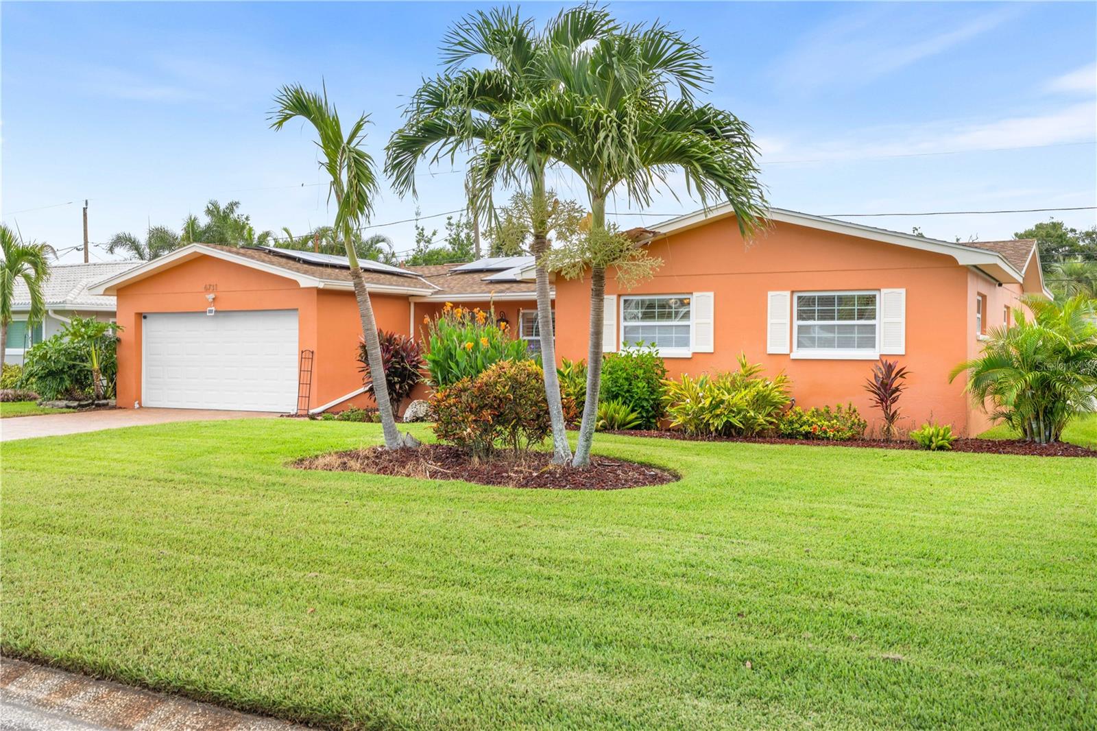 Welcome to this beautifully cared-for home nested in the desirable Crossroads Estate neighborhood, located in the heart of St. Petersburg. Situated in a NO Flood zone, no HOA fees, this delightful 4BR/2BA single residence offers independence, comfort and flexibility. As you step inside, you’ll be welcomed by a spacious, light-filled open layout – perfect for entertaining. The generous living and dining areas seamlessly connect to the kitchen and family room, creating a warm and inviting atmosphere ideal for hosting guests or simply relaxing at home. For added privacy or quiet time, barn doors and pocket doors allow you to close off the kitchen and family room. The kitchen features elegant wood cabinetry, granite countertops, a gas stove, stainless steel appliances, and a spacious pantry for added convenience. A charming kitchen window overlooks the fenced backyard oasis, where you'll find exotic plants and a custom waterfall. The family room includes sliding glass doors with integrated blinds, leading to a fully enclosed lanai - perfect for morning coffee, yoga sessions, or winding down in the hot tub after a long day. Throughout the home, luxury bamboo flooring, abundant natural light, and thoughtful design touches such as plantation shutters, upscale ceiling fans, cove molding, and a smartly designed floor plan offer comfort, style, and privacy for all. The primary suite offers dual custom closets and an updated ensuite bath with frameless walk-in shower. The attached 2 car garage has a lot of storage space, extra space in the attic. Other highlights: PAID-OFF Solar System ($41/month electric bill)!!!; 2017 High-efficiency A/C with dehumidifier; Programmable thermostat; Tankless water heater, Newer windows, Plywood hurricane shutters; Roof 2011; Washer/Dryer included. Conveniently located just 10 min from Treasure Island and the beaches, you’ll enjoy your paradise with easy access to everything the area has to offer—major highways, a nearby hospital, shopping centers, banks, the post office, dining, a movie theater, and a short 15-min ride to vibrant downtown St. Petersburg for luxury experiences or nightlife. For outdoor enthusiasts, you're just 10 min from tennis, pickleball, and basketball courts, outdoor gym, playgrounds, swimming pool, dog park and the 47-mile Pinellas Trail all the way to Clearwater Beach. There’s always something to do just steps from your door! This move-in-ready is a rare find. Schedule your private showing today and discover the Florida lifestyle that awaits in this quiet, pride-of-ownership community!