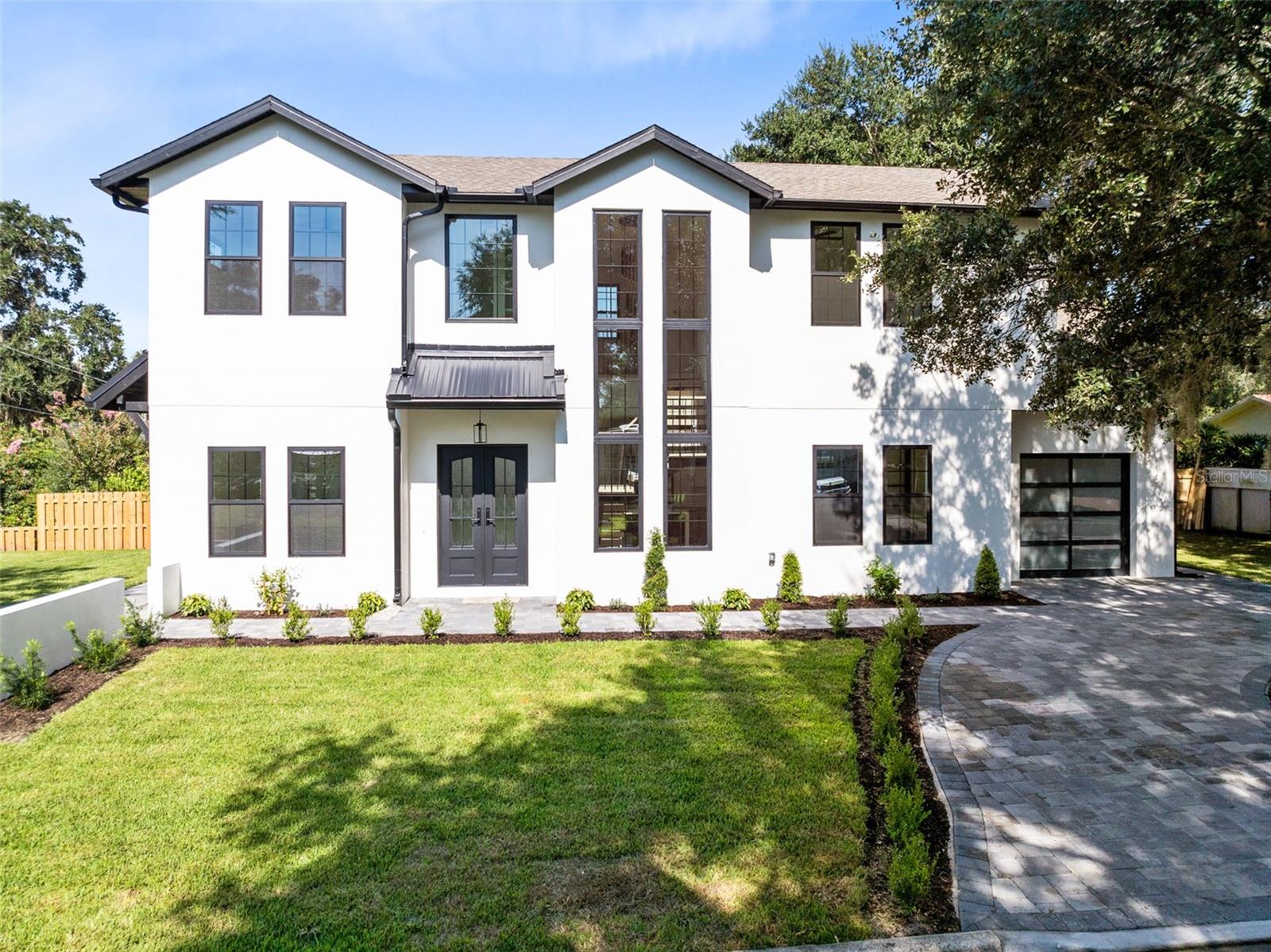 Experience the epitome of modern luxury living—where location, design, and comfort converge in perfect harmony.
This newly constructed modern farmhouse offers 3 bedrooms, 2.5 bathrooms, and 2,242 square feet of living space, thoughtfully designed to elevate everyday living.
Upon entering, the grand foyer welcomes you with minimalist elegance, setting the tone for the entire home. The open-concept layout seamlessly blends spacious living areas, making them ideal for both relaxation and entertaining. Soft, cozy materials throughout the home create a warm, inviting atmosphere—every surface crafted to feel gentle and refined.
The designer kitchen is a culinary centerpiece, featuring custom cabinetry, quartz countertops, high-end appliances, and a sleek island perfect for gatherings. The adjoining living room is bright and airy, anchored by an electric fireplace and enhanced by a striking custom bar wall with exposed brick, built-in shelving, and dual wine refrigerators. A dedicated office and a formal dining room on the main level provide functional flexibility for work and gatherings.
The artful centerpiece of the home—the floating staircase—is framed by soaring windows and illuminated by a sculptural chandelier, making a bold architectural statement. Upstairs, the primary suite offers a true retreat with a spacious walk-in closet and a spa-like bath featuring dual vanities, a glass-enclosed double shower, and matte black fixtures. Two guest bedrooms and a dedicated laundry room with a stackable washer and dryer complete the upper level.
Step outside to a professionally landscaped yard with a pavered semi-circular driveway and expansive green space, all set on a desirable corner lot.
Nestled on a quiet, tree-lined street just minutes from Park Avenue, this home offers the best of Winter Park living. Zoned for A+ rated schools and conveniently located near Winter Park Hospital, Rollins College, fine dining, shopping, museums, and major highways—this is luxury living with lifestyle in mind.
Schedule your private showing today and make this exceptional residence your own.