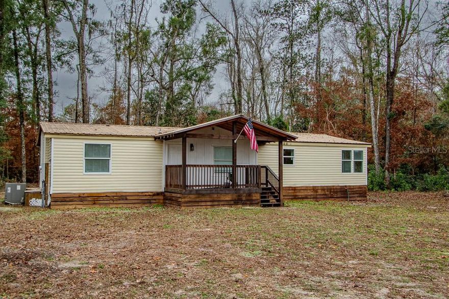 This beautifully remodeled modular home was fully updated from 2024–2025 and offers modern comfort with a peaceful, private setting. Major upgrades include a new well, new septic system, new HVAC, new water heater, vanities, cabinets, new electric panel, and all-new 2025 appliances—providing peace of mind for years to come. 
Inside, you’ll find luxury vinyl plank flooring throughout, elegant wainscoting, wood-cased windows, built-in shelving, and a cozy electric fireplace. The kitchen features stained butcher block countertops and brand-new appliances, perfect for both everyday living and entertaining.
The spacious primary suite includes a barn-door entry, custom shelving, and a large walk-in tiled shower. The bedrooms have generous size walk-in closets, while the second bathroom has a new tub/shower combo. New ceiling fans add comfort throughout the home.
Enjoy outdoor living on the 16x8 covered front porch with railing or the small back porch, all set on just under one acre of cleared land with surrounding woods for privacy.
Located in Three Rivers Estates, this home offers voluntary membership for private access to community parks and boat ramps. You’re surrounded by the Ichetucknee, Suwannee, and Santa Fe Rivers, and just minutes from downtown —perfect for nature lovers, boating, and outdoor recreation.