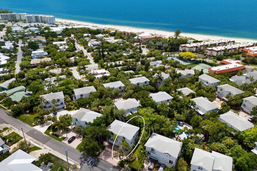 Step into elevated island living, less than two blocks from Anna Maria Island’s pristine Gulf shoreline.
This rare opportunity in the highly sought-after North Beach Village presents an updated 3-bedroom, 2.5-bath townhome designed for effortless coastal luxury.

A spacious two-car garage with epoxy flooring, abundant storage, and versatile flex space sets the tone for convenience. Upstairs, the open-concept living area is bathed in natural light, showcasing a modern chef’s kitchen with 42-inch shaker cabinetry, stainless steel appliances, Skye Cambria Quartz countertops, a custom backsplash, and inviting bar seating. Two expansive sliding glass doors seamlessly extend the living space to a private Trex-decked patio—perfect for sunset cocktails or morning coffee with island breezes. Across the main level, you’ll find a formal dining area with its own patio retreat, a chic powder room, and a custom-designed laundry room.

The upper level reveals a serene primary suite complete with a brand-new California Closet, a fully reimagined spa bath, and a private balcony for moments of escape. Two additional guest rooms feature custom closets—one enhanced with a built-in Murphy bed, desk, and shelving for stylish flexibility.

Outdoor living is just as refined: a ground-level patio offers a grill station, sink, and outdoor shower for effortless entertaining after a day at the beach. Premium upgrades include hurricane-impact windows and doors, a reinforced garage door, custom cabinetry throughout, Trex decking, LED lighting, tankless water heater, plus a new roof and HVAC.

Residents enjoy a newly refurbished heated pool just steps away, while the community allows weekly rentals—an exceptional opportunity for investment potential alongside personal enjoyment or just an amazing income producer. Best of all, there are no assessments.

Here, you’re not just purchasing a home—you’re embracing the coveted North Beach Village lifestyle, with Anna Maria Island’s sugar-white sands, vibrant eateries, and boutique shopping all at your doorstep.