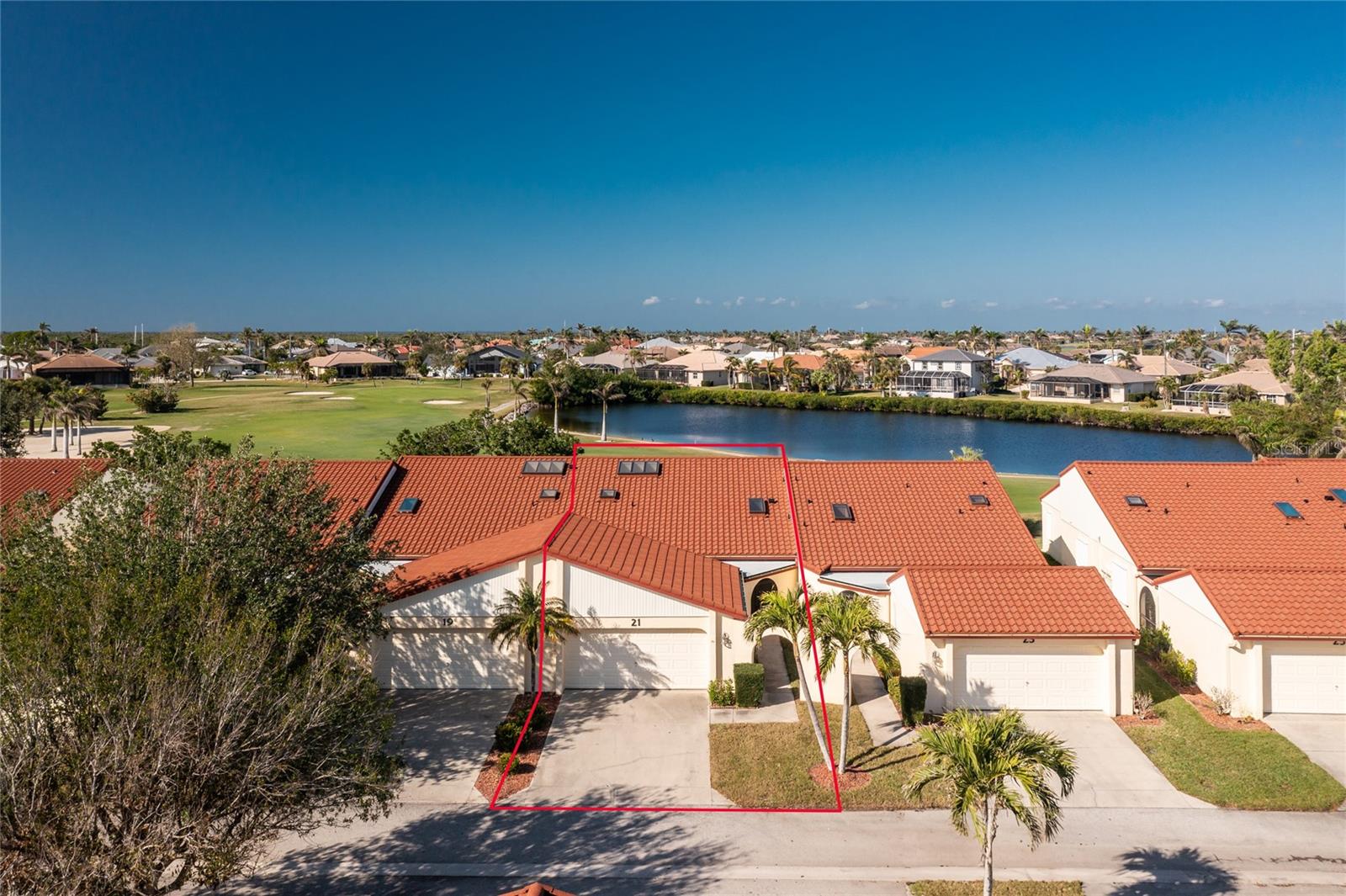 WOW!! Is what you will say when you see this beautiful Punta Gorda Isles Golf Course Villa for only $189,900 and monthly fees of only $660! This Villa has never experienced any interior damage or flooding in any past hurricanes, and the seller is an original owner. It is a spacious 2 bedroom plus a large den/bonus room, 2 bathrooms, 2 lanais and a 2-car garage. The back lanai has a wonderful southwest exposure overlooking the lovely lake, St Andrews Golf Course (with available memberships) and incredible sunsets! It also has Glass Sliders for the cool winter days and accordion hurricane shutters on the exterior. The front screened Porch-Patio is nice and private with brick paver flooring; this would be a great spot for the large Grille and another seating or even a hot tub! The interior has an all-white tile floor that would go with any decor. The kitchen has granite counters, white appliances with built in microwave, flat top stove and large refrigerator with an icemaker. There is also room for a breakfast nook! The closet in the kitchen houses the washer, dryer, hot water heater and some storage. The large great room shares the lovely view off the Lanai as well. It also has cathedral ceilings with 7 skylights throughout and built in cabinets for your dining area! The primary bedroom has 2 walk-in closets with the larger having been upgraded with a California closet design style. Both baths have granite counters. The 15X11 bonus room/den-study is such an added bonus and includes a large skylight to make it light and bright. Golf Course Villas (the name of the condominium) has a large pool, shuffleboard courts and a quaint gazebo for all to share. New Metal Roofs installed in 2024 with the $9,650 Assessment paid in full. All exterior buildings have been painted in 2025, and the private road has been repaved in February 2025. Great time to be buying in this well maintained complex and enjoy living the good life Punta Gorda has to offer! Great neighbors are an added bonus! Call today to see as this won't last long!