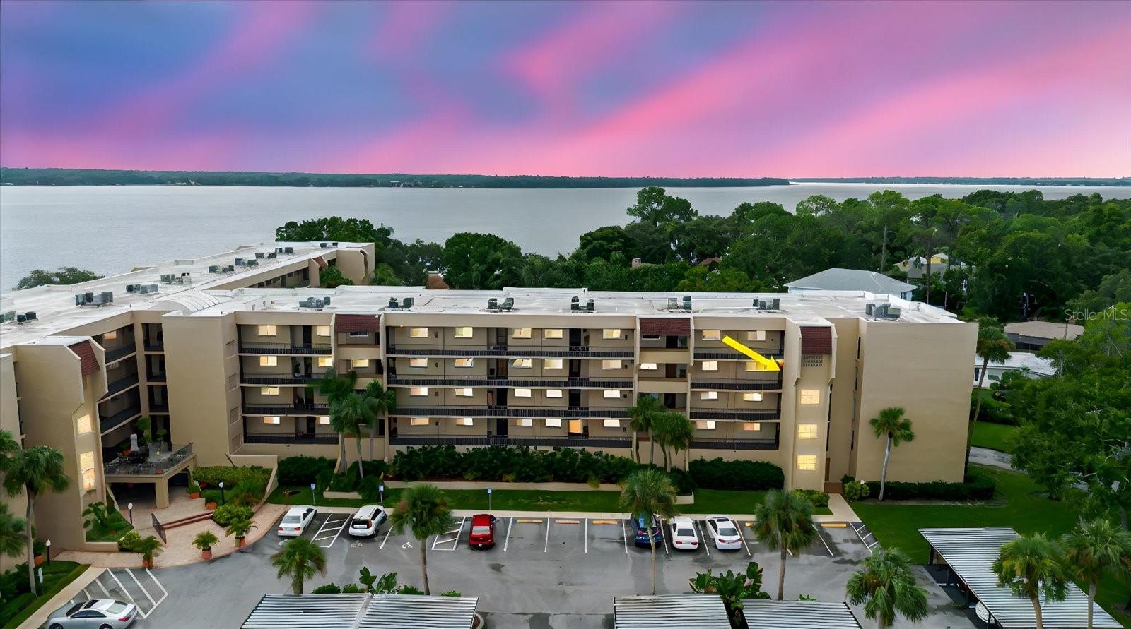 Discover the perfect blend of comfort, convenience, and Florida charm in this beautifully updated, move-in ready 3rd-floor condo. Tucked safely in a no-flood zone and paired with a low HOA fee, this home is designed for easy living and peace of mind. Offering 2 bedrooms, 1 bath and a deeded covered parking spot, plus extra storage, this condo truly has it all. Inside, you’ll find a bright, open floor plan where the kitchen, dining, and living areas flow seamlessly together, ideal for both entertaining and everyday living. The spacious master suite features access to the private balcony, while the second bedroom is equally inviting with plenty of natural light. The living room also opens to the balcony, where you can relax with serene lake views. Convenience is key here, an elevator in the building ensures easy access, while impact windows add extra comfort and security. Step outside and enjoy the resort-style amenities that make this community so desirable. Spend your days lounging by the heated pool, staying active in the fitness center, or enjoying a game of tennis, pickleball, or shuffleboard. Unwind with a book in the library, challenge friends at billiards, or host gatherings in the clubhouse. Love the out doors? Take advantage of the BBQ area, go fishing on Lake Tarpon, or enjoy boating and skiing with access to private docks and slips. The HOA covers water, sewer, trash, exterior maintenance, insurance, and full access to recreational facilities, ensuring easy ownership. Located just minutes from Tarpon Springs’ historic Sponge Docks, downtown shops and dining, pristine beaches, golf courses, parks, hospitals, and the Pinellas Trail, this condo offers both convenience and charm, making it the perfect place to call home or use as a seasonal retreat. Don’t miss the chance to enjoy the Florida lifestyle you’ve been dreaming of!