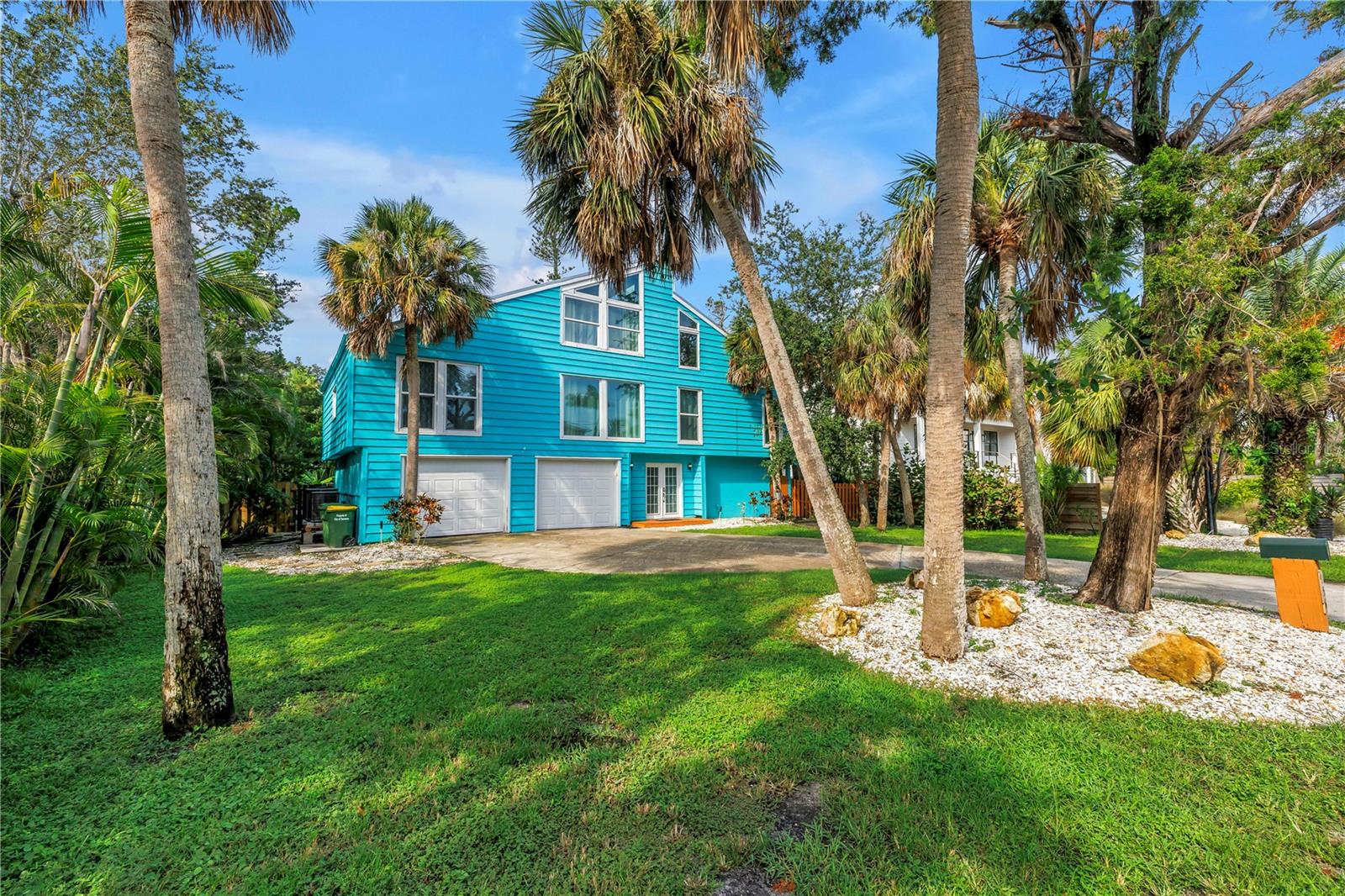 Situated in the sought-after Bay Isle community on Siesta Key, this exceptional three-level pool home combines the best of upscale coastal living with impressive rental performance. Designed to host gatherings of all sizes, it is perfectly suited as a primary residence, vacation escape, or income-producing property. In 2024, it brought in $132,419 in gross rental income, with 2025 projections at $120,681, showcasing its strong investment appeal.
Just a short stroll to Shell Beach and minutes from Siesta Key Village and the world-renowned Siesta Key Beach, the home offers unmatched access to award-winning white sand, vibrant dining, and boutique shopping. A complete renovation in 2019 transformed the property with a new metal roof, hurricane-impact windows, patio and garage doors, upgraded AC systems, and an oversized resurfaced lap pool with all-new equipment, including a heat pump. Over 50 Areca palms frame the lush tropical landscaping, providing beauty and privacy while remaining easy to maintain.
The outdoor living space rivals a private resort, featuring a sparkling pool, spacious patio, and tranquil surroundings ideal for lounging or entertaining. Inside, natural light fills the open floor plan, creating seamless flow to the outdoor areas and making it a true entertainer’s haven. Impeccably maintained and move-in ready, this Bay Isle residence offers a rare opportunity to enjoy the island lifestyle while benefiting from consistent rental income.
