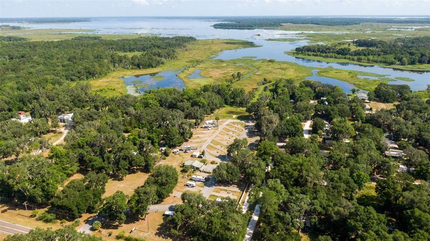 Impeccably maintained Turn-Key 6.26 AC 32 site RV Park on Orange Lake. Each site has 30/50 amp 110 plug (individually metered), water and septic connection. 768 sqft Office/Laundry/Bath House building, private boat ramp.