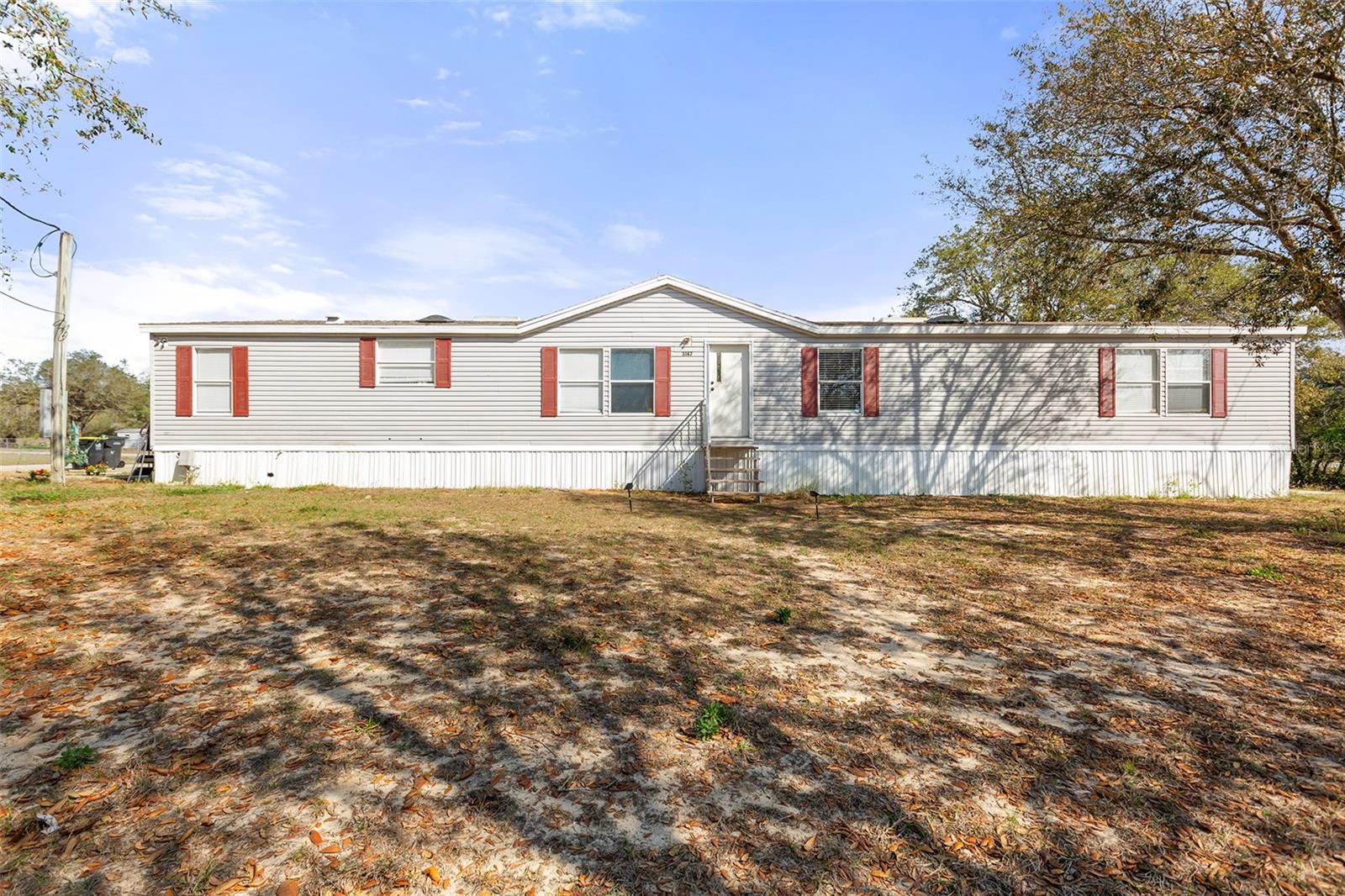 PRICE IMPROVEMENT! Welcome to your very own slice of paradise with NO HOA! This spacious 4 bedroom double-wide mobile home is situated on a slightly less 1/2 acre corner lot, providing plenty of space and privacy. A touch of country in a peaceful and rural setting, but also convenient to shopping and many restaurants. Step inside where you are greeted with an open floor plan, high ceilings, and new laminate flooring. The living, dining and hallway features stylish crown molding and decorate chair railing, giving a richness design to the home. Neutral and pastel colors create a warm and inviting atmosphere throughout. Kitchen offers stainless steel appliances, abundance of counter space with beautiful new granite, and plenty of cabinets for all your culinary needs. On the opposite side of the home is an oversize family room that can also serve as a game room, media room, or anything your heart desires. Enjoy having a private owner's oasis, separate from secondary bedrooms. The ensuite bath features dual sinks, large garden tub, and separate shower. Recent improvements include new roof (2020), new water heater (2020), new washer/dryer, and new energy-efficient toilets (2022). Relax or enjoy grilling from the comfort of your deck. The neighborhood park is an added bonus and a wonderful place for hours of fun and recreation. Don't miss your chance to add your personal touches to create your own special memories.