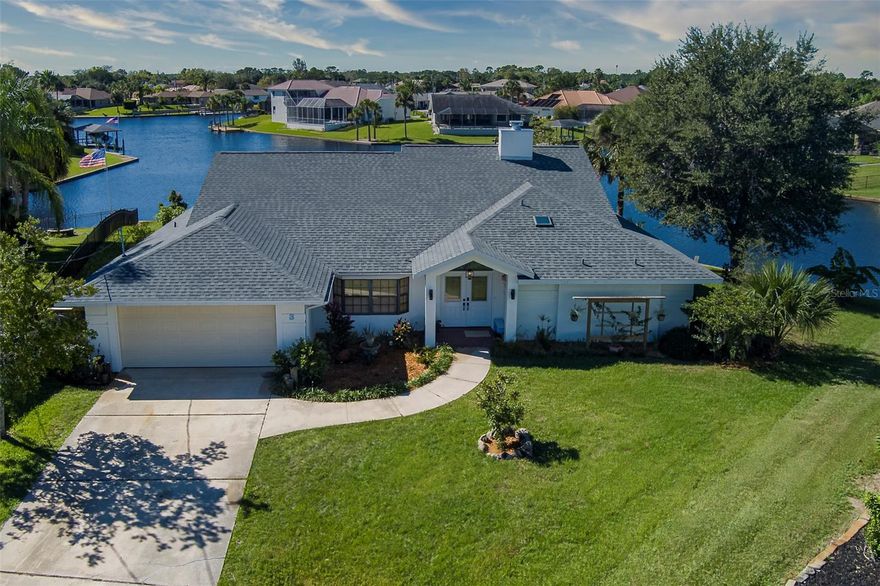 Welcome to your waterfront retreat in Palm Coast coveted sailboat country. The rare 180-foot southern exposure tip lot overlooks the confluence of four canals that create the wide-open beauty of Crazy Horse Cove.  The Intracoastal is only a six minute bridge-free boat ride away from the renovated 50-foot deep-water dock — perfect for your catamaran, yacht, fishing boat, or trawler. There’s also a separate boat lift and additional guest dock space. With no HOA or CDD fees and located in an “X500” flood zone, this property offers peace of mind.
Fully renovated by the owner/contractor, this solid concrete block home offers 2,701 square feet of thoughtfully updated living space. Improvements as of 2021 include a new roof, interior and exterior paint, A/C and ductwork, luxury vinyl and tile flooring, custom cabinetry in kitchen and baths, solid core doors with custom trim work plus 6" base boards throughout. The split plan is ideal for multi-generational living or short-term rental use.
The large gallery style foyer welcomes you to a light-filled living area where water views take center stage. The chef-inspired kitchen features custom cabinetry, corner pantry, granite countertops and 9' island. Note the nearby walk-in pantry/laundry. Appliances include a Bosch induction cooktop and refrigerator. The living room has high ceilings with custom built-ins and a cozy wood-burning fireplace.
The spacious owner’s suite with sitting area, includes a large walk-in closet and shoe closet. The ensuite bath has a freestanding soaking tub with a waterfall faucet and handheld shower. The large 6' walk-in shower offers both ceiling mount and hand-held fixtures plus glass doors and Italian porcelain tile surround. On the other side of the house, enter the beautifully updated private guest wing offering 2 bedrooms. The bath featuring custom cabinets and a ceiling-mounted rain shower. French doors lead to the fourth bedroom currently serving as an office and is perfectly suited as flex space.
Outdoor living shines here. Relax under the new pergola with custom grilling station (Big Green Egg conveys) or unwind in the new spa on the screened lanai overlooking the wide canal. A large two-car garage with workbenches adds functionality, while the quiet cul-de-sac location enhances privacy. There's a private irrigation well. 
The yard includes fruit trees — lemon, mango, avocado, olive and banana — and your backyard becomes a front-row seat to dolphins, manatees, tarpon, and coastal birds. Did I mention the custom putting green? 
Just minutes away is European Village, offering shops, restaurants, and a popular Sunday farmers market. Pristine Atlantic beaches are only 10 minute drive away. You’re also conveniently located 35 minutes to Daytona Beach International Airport and 25 minutes to historic St. Augustine.
Palm Coast, a thoughtfully planned community, features over 130 miles of interconnected walking and biking trails, two modern community centers (including one with an Olympic pool, tennis, and pickleball), plus 17 public and private golf courses. New state-of-the hospitals are nearby. 
3 Creek Court offers the ultimate Florida lifestyle — boating, beaches, golf, nature, and vibrant coastal living — all from your own private waterfront paradise.