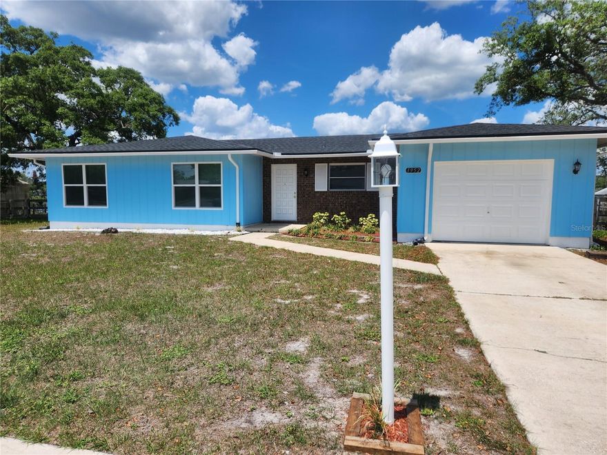 THIS IS A BEAUTIFUL LAKEFRONT RENOVATED HOME HAVING WATER VIEWS FROM ALMOST EVERY ROOM. THIS ELEVATED PROPERTY SITS ON OVER 1/2 ACRE AND DOES NOT NEED FLOOD INSURANCE.  THIS IS A 3 BEDROOM / 2 BATH HOME HAVING A NEWER ARCHITECTUAL SHINGLE ROOF (2023), NEW WATER HEATER, NEW FLOORING (PORCELAIN TILE, CERAMIC TILE, CARPET), CROWN MOLDING, SOME NEWER WINDOWS, REMODELED KITCHEN (WITH NEW APPLIANCES AND GRANITE COUNTERTOPS) AND UPDATED BATHROOMS.  THIS REFRESHED HOME HAS BEEN RECENTLY PAINTED (BOTH INTERIOR AND EXTERIOR) AND OFFERS A WATER-INFLUENCED LIFESTYLE AT AN AFFORDABLE PRICE-POINT.  THIS SPACIOUS PROPERTY HAS A SEPARATE FAMILY ROOM, 1-CAR GARAGE WITH WORKBENCH AND OPENER, FENCED BACK YARD, MATURE LANDSCAPING, AND A LARGE PATIO OVERLOOKING ANGELA LAKE.  THE PRIMARY BEDROOM HAS A WALK-IN CLOSET AND THE PROPERTY HAS CITY WATER AND SEWER (RARE FOR DELTONA).