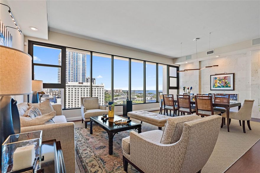 A spectacular and extremely rare two-story penthouse with breathtaking Tampa Bay & sparkling City views located in the coveted boutique-style Salvador condo, in the heart of downtown St. Pete! This custom-built and professionally designed one-of-a-kind residence exudes the elegance of a fashionable art gallery with all of the comforts of a warm and inviting home. The home’s floor plan, flow and luxe amenities make it ideal for both entertaining and the family. Upon entering the main living level, you will be blown away by the great room’s window walls with sweeping city and Bay views. The home features 4,278 sq. ft. of living space, a spectacular owner’s suite and bath, two en-suite guest rooms, four and one half bathrooms, a sumptuous library, an office / den, formal living and dining great-room, family room with double sided gas fireplace, media room with a full bar, deluxe Euro-style kitchen with stainless appliances & gas cooking, catering kitchen with laundry, custom cabinetry though out, high-end designer lighting, 10’+ ceilings on main living level, cork floors, marble tile, Coquina stone accent walls, tremendous closet space, and so much more! The bonus is that you will have the best seat in the house, at Al Lang Stadium, as you enjoy your bird’s-eye view of the next Tampa Bay Rowdies game from one of your three balconies! The residence comes complete with three parking spaces and climate-controlled storage. Note* The library can be converted back to a fourth bedroom & both floors, in the unit, are accessible via the building elevator. The Salvador offers secured building access and a third-floor amenity deck with a heated saltwater pool, spa, fitness center, clubhouse, grilling station, sculpture garden, fire pit, and a dog park with washing station. The Salvador is St. Pete’s first Green certified building. The Salvador's prime downtown location offers residents unsurpassed urban living with walkability to hip restaurants, shopping, museums, galleries, waterfront parks, entertainment venues, nightlife, cafes, marinas, galleries, the St. Pete Yacht Club, outdoor markets, sporting venues, the St. Pete Pier, USF, and more! This spectacular residence exudes elegance at every angle and is the epitome of high-end downtown living! Buyer to verify all measurements.