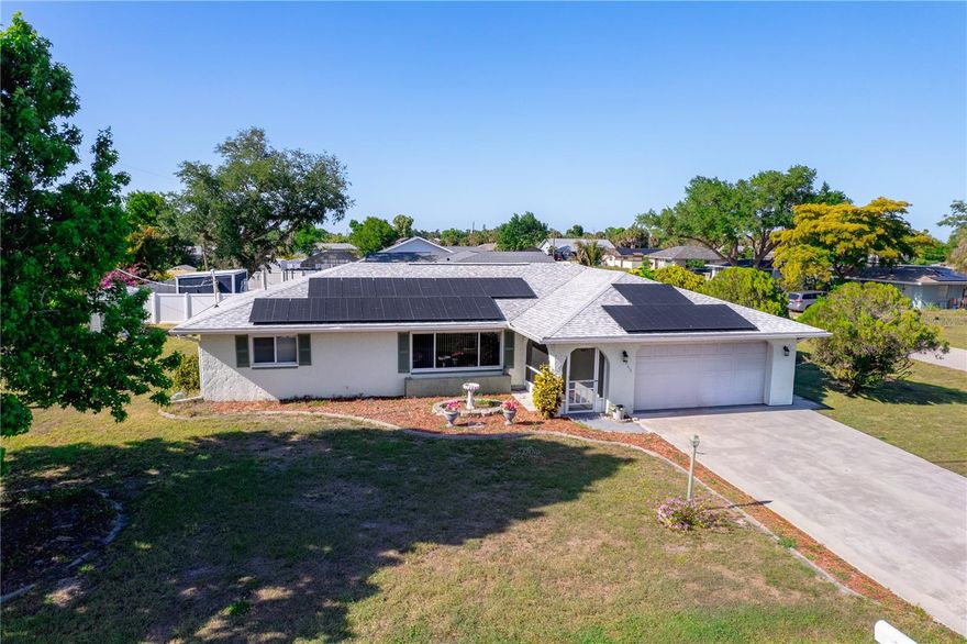 Clean, move-in ready, and set up for easy living, this 3-bedroom, 2-bathroom home is situated on a spacious corner lot with mature trees, a utility shed, and an oversized lanai. The updated kitchen features granite countertops, newer appliances, and upgraded cabinetry with convenient sliding shelves. Major improvements have already been completed, including impact windows and sliders, an updated electrical panel, and added hurricane straps. The expansive lanai is a true highlight, offering ample space along with a custom-built bar perfect for entertaining or relaxing outdoors. Tucked away on a quiet street while still being close to shopping, dining, and the Port Charlotte Beach Complex, this home offers both comfort and convenience. A solid option for buyers looking for an updated, well-maintained property that’s ready to go.