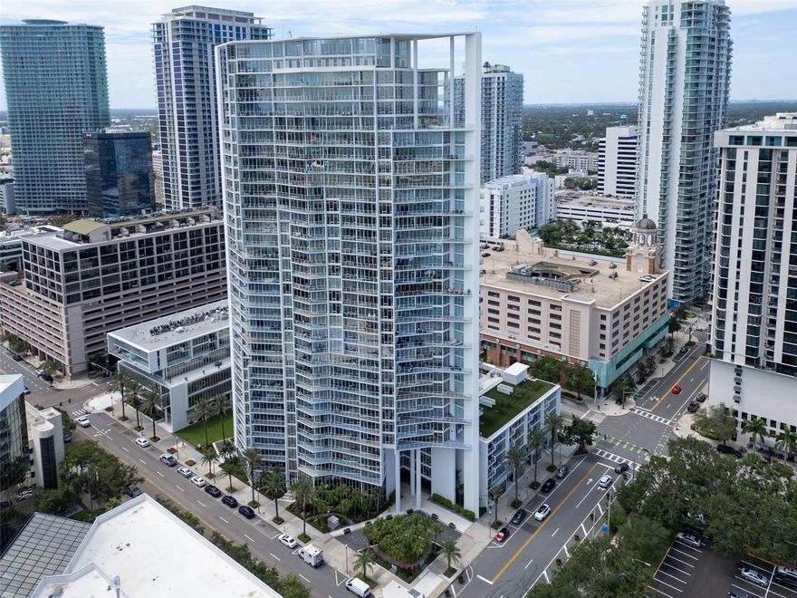 Spacious elegance. Walls of glass. Waterfront Balconies.

This extraordinary residence is defined by light, scale, and jaw-dropping views. With two unobstructed waterfront balconies, the home overlooks Tampa Bay, The Pier, two marinas, the Saturday Morning Market, and the dynamic energy of Albert Whitted Airfield. A total of 36 floor-to-ceiling windows wrap the main living spaces, creating the feeling that every room is suspended above the water.

A grand entry sets the tone, opening into an expansive layout designed to impress. The oversized primary suite offers a serene retreat with an enlarged, custom closet featuring adjustable shelving and a spa-inspired bath accented by custom-cut granite countertops and integrated soap dispensers.

The guest suite is equally impressive-easily accommodating a king bed or dual twins with ample furniture-and is elevated further by its own private waterfront balcony, delivering an unforgettable guest experience.

A stylish powder room adds a touch of playful sophistication with an LED color-changing faucet, a detail guaranteed to surprise and delight.

The kitchen is a true statement piece. A dramatic granite waterfall island anchors the space, complemented by a full granite backsplash that extends seamlessly to the ceiling. The extra-wide countertop offers generous bar seating, while the custom-cut, leathered granite subtly sparkles as evening light washes across the room.

The glass-wrapped dining area flows effortlessly into a spacious living room designed to accommodate an 85-inch or larger television, without sacrificing elegance. Kitchen, dining, and living spaces all open directly to the main balcony-creating a seamless indoor-outdoor experience framed by sweeping bay views.

Residents enjoy full-service amenities including 24/7 concierge, a resort-style infinity pool surrounded by lush landscaping, private cabanas, outdoor grilling areas, refined social spaces, and a state-of-the-art fitness center.

Step outside and into the heart of St. Petersburg, consistently ranked among the nation's most livable and walkable cities. From the 2.4-mile waterfront park and world-class museums to marinas, dining, shopping, and the iconic St. Pete Pier, everything that defines downtown living is just moments away.

This is a rare opportunity to own a dramatically upgraded waterfront residence in one of downtown St. Petersburg's most iconic luxury towers.