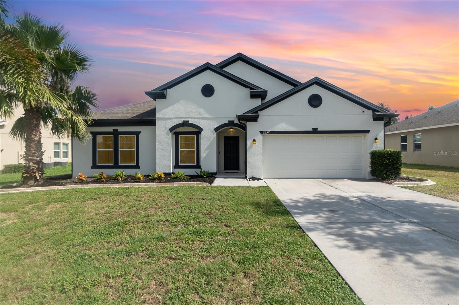 This beautifully maintained 4 BR/2BA home features an open-concept, split floor plan. Located in a newer gated community with spacious lots. The Great Room flows seamlessly into the chef-inspired kitchen, complete with solid surface countertops, stainless steel appliances, farmhouse sink, and 42” cabinetry. A versatile flex space offers the perfect setting for a formal dining room, office, playroom, or gym. The Primary Suite includes a large walk-in closet, dual vanities, a private water closet, and a luxurious walk-in shower. Additional highlights include an indoor laundry room with utility sink (washer and dryer included), ceiling fans, recessed lighting, wood laminate flooring, and window coverings throughout. The interior and exterior recently repainted. Enjoy outdoor living in the screened lanai with an extended paver patio — ideal for grilling and entertaining. The oversized backyard is fully enclosed with vinyl fencing, Landscaped yard with paver-edged flower beds complete this move-in ready gem. Call Today!