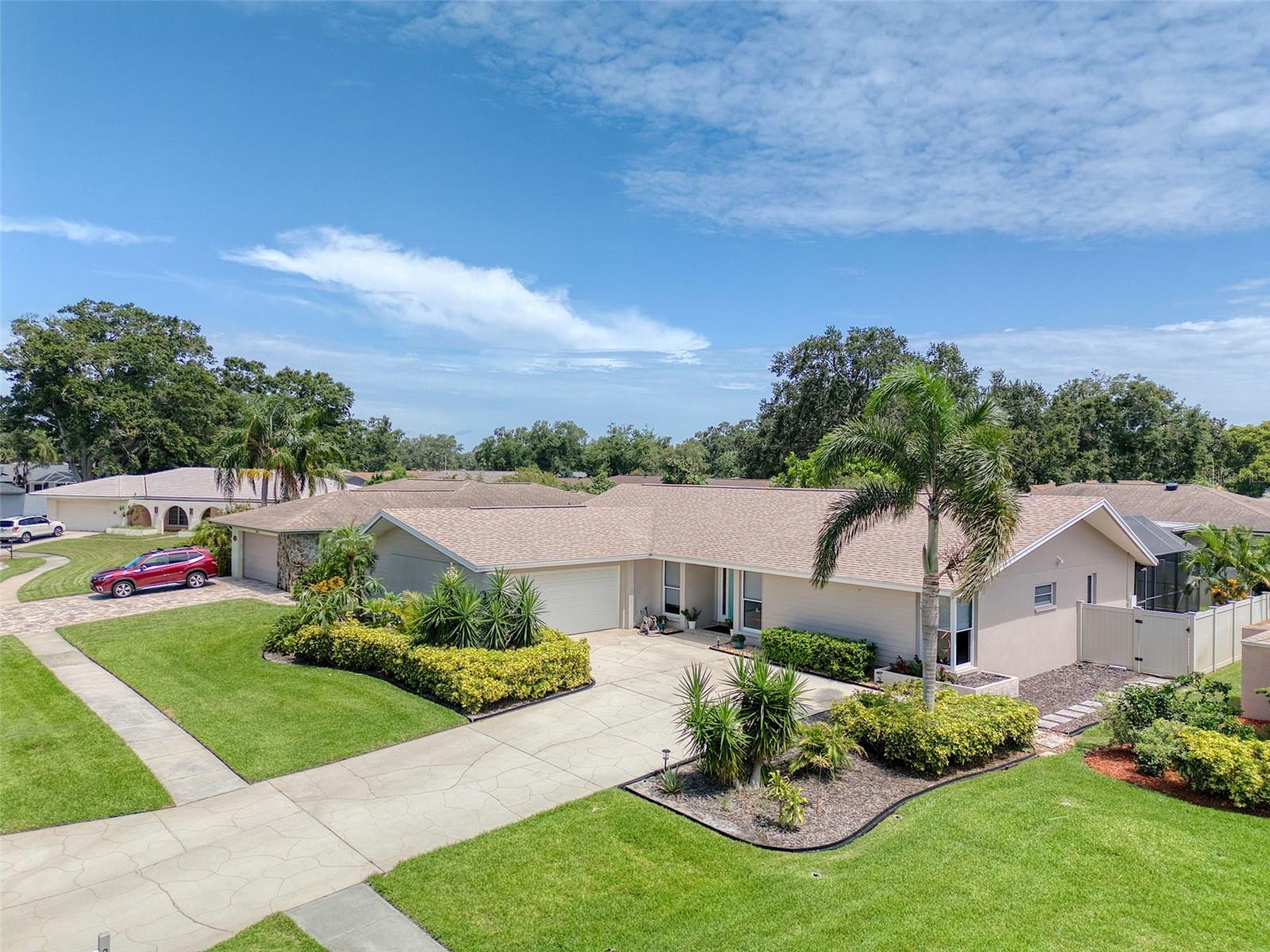 Absolutely stunning is the only way to describe this renovated 4 bed, 3 bath, 2 car garage pool home on an Oak Tree lined cul-de-sac in the desirable of Countryside neighborhood. This high and dry chic home is NOT in a flood zone and sits on a 9600 sq ft manicured lot. This delightful home boasts a large living room, formal dining room, 4 generous sized bedrooms, 3 bathrooms, a large inside laundry room, a family room and a beautiful open plan kitchen ~ with quartz countertops, marble backsplash, an island with seating, and stainless steel appliances including brand new double wall ovens and dishwasher (2025), and 42" white cabinetry. The primary bedroom is split from the other 3 bedrooms for privacy and has a newly renovated ensuite bathroom with stunning granite countertops and white cabinetry and a frameless glass shower surround. Off the family room, the impact sliders (2020) pocket to reveal a serene patio oasis creating a seamless blend of indoor/outdoor entertainment living. The stunningly beautiful backyard features a large entertainment deck and a luxurious heated salt water pool (2017) with a beach entry and fountain which creates a peaceful ambiance in this private fully fenced backyard. This gorgeous home is move in ready with tasteful touches such as wainscoting, neutral color tones, crown molding and upmarket laminate flooring and NO CARPET. There is plenty of natural light streaming in through the impact windows and room to grow in this well laid out floor plan. This meticulously maintained home has a newer main roof (2020) and flat roof (2017) and the A/C was replaced 2018, water heater is approx. 2 years old and a new electrical panel installed in 2020. This delightful home is close to shops, downtown Dunedin, beaches, airport and excellent schools. This home ticks all the boxes and is a must see! Come live the Florida lifestyle in this quintessential Florida lifestyle home.