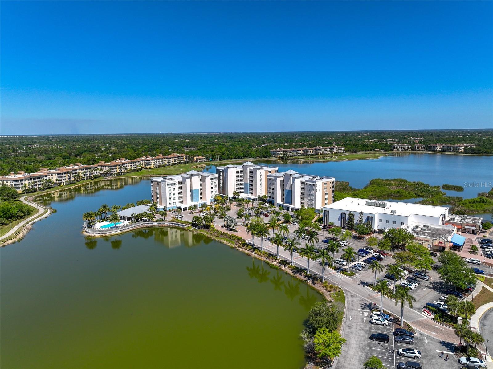 Stunning Lakefront Luxury Condo at Waterfront at Main Street, Lakewood Ranch
Experience the perfect combination of tranquility, luxury, and convenience with this immaculate Cayman model condo, offering 1,558 sq. ft. of elegant living space. This rare end-unit features 3 bedrooms, 2 full bathrooms, and breathtaking panoramic views of Lake Uihlein, overlooking the Lakewood Ranch Country Club Golf Course.
Enjoy peaceful mornings on your private screened-in balcony with a cup of coffee or unwind in the evening with a glass of wine while taking in stunning sunsets and views of local wildlife. Designed with high-end finishes, this condo offers:
• Wood-look porcelain tile flooring throughout the main living areas
• Granite countertops and dove-tail cabinetry in the kitchen and bathrooms
• Moen upgraded fixtures and raised-height vanities in both bathrooms
• GE Profile stainless steel appliances
• Impact-resistant windows for added peace of mind
• Split floor plan offering privacy with the primary suite separate from the guest bedrooms
The third bedroom offers flexibility and can easily function as a home office, den, or additional guest space.
Community Amenities
Living at Waterfront at Main Street offers resort-style amenities, including:
• Heated saltwater pool and spa with scenic lake views
• Outdoor kitchen, grilling areas, and fire pit for gatherings
• Fully equipped fitness center
• Social clubhouse hosting regular events and activities
• Walking, biking, and kayaking opportunities around Lake Uihlein
• Convenient access to Lakewood Ranch Main Street with shops, restaurants, a movie theater, and miniature golf
• Monthly events like free outdoor concerts, weekend vendor fairs, art shows, and antique car exhibits
Additionally, this condo is just minutes from award-winning beaches, top-rated golf courses, the UTC Mall, Sarasota, Bradenton, and major highways.
What the Current Owners Love Most
The current owners have loved living in this beautiful home and shared some of their favorite things:
1. The unbeatable location — everything they need is within walking distance.
2. Gorgeous views of wildlife and sunsets from the lanai.
3. A strong sense of community with friendly neighbors and frequent social events.
4. The perfect size — spacious but easy to maintain.
Additional Highlights
• This property qualifies for a 1% lender incentive with a preferred lender, subject to lender approval.
• Furniture available separately
This is a rare opportunity to own a beautiful lakefront condo in one of Lakewood Ranch’s most desirable communities. With its prime location, stunning views, and resort-style amenities, this home won’t stay on the market for long.
Schedule your private tour today!