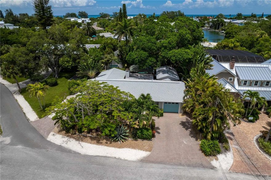 Brand new A/C and a putting green!!! Welcome to 108 Los Cedros, a stunning property located in the beautiful city of Anna Maria. Situated in a quiet neighborhood just a short walk to the sugar sand beaches of the Gulf of Mexico this luxurious home is perfect for those seeking a vacation retreat or a permanent residence in paradise. Only 4 houses from historic Pine Avenue with its shops and restaurants, this house also boasts 7 parking places which makes it a perfect home to entertain family and friends or for group gatherings. This canal front property has 4 bedrooms and 4 bathrooms with a 789 sq foot non-conforming guest cottage that offers a quiet air-conditioned space with a pool table and game room. The beautiful and functional kitchen features custom cabinets, Jenn-Aire stainless steel appliances, quartz counter tops, a wine cooler and ice maker. Perfect for the chef in your family. There are 3 master bedrooms with En-suite bathrooms, all 3 have private entrances to outside. The screened in heated pool and patio features a gas grill, outdoor dining space and entertainment area. There are multiple lounge areas throughout the property where you can kick back, relax and enjoy the true feel of a tropical paradise and a view of the canal. There is a private dock (new in 2018) with a kayak launch and 10,000lb boat hoist (2018). New outdoor landscape lighting and a putting green added in December, 2022. Pavers redone, repaired and resealed in May 2022. Addition of 4th bedroom completed in November of 2021 with a new mini-split air conditioner. New roof in 2019. New mini split for the master bedroom in 2021. Updates in 2018 included a new kitchen, including appliances, new floors and new dock. 2023 a new 4-ton A/C unit for the main house. There is an outdoor shower to clean up after the beach. With its prime location, luxurious amenities and comfortable accommodations this is a perfect vacation rental or permanent residence. Don't miss out on the opportunity to own your own slice of paradise. Schedule a private showing today.