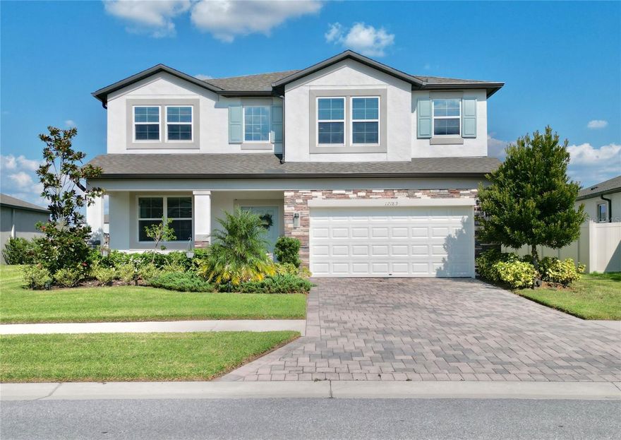 Enjoy this stunning 5-bedroom, 3-bath residence offering over 3,500 sq. ft. of luxury living on nearly ¼ acre, complete with peaceful lake views. Built in 2023, this home seamlessly blends modern elegance with everyday functionality.

From the brick-paver driveway and welcoming front porch with stone accents to the bright and spacious foyer, every detail was designed to impress. The open-concept floor plan features high ceilings, neutral finishes, and tile flooring throughout the main living area.

The gourmet kitchen includes granite countertops, 42" cabinets with crown molding, a walk-in pantry, under-cabinet lighting, and premium stainless-steel appliances, plus space for an additional pantry. The charming coffee nook offers panoramic lake views, while the large family room flows effortlessly onto the oversized covered lanai—perfect for relaxing or entertaining guests.

Upstairs, you’ll find the luxurious primary suite with a spa-style bathroom featuring dual granite vanities, an oversized shower, a private water closet, and a spacious walk-in closet. The second floor also includes a loft ideal for a game room or home theater, along with three additional bedrooms. On the main level, a guest bedroom with a nearby full bathroom and pool access provides convenience and privacy.

Additional Features:

3-car garage with extended laundry room

Upgraded lighting, gutters, 6-inch baseboards, and in-wall pest control system

Large backyard with space to build a private pool

Located in the highly desirable Talavera community—golf-cart friendly—residents enjoy resort-style amenities including a pool, splash pad, clubhouse, tennis and basketball courts, and weekend food-truck events. All of this just minutes from US-41, SR-52, top-rated schools, shopping centers, restaurants, and the Suncoast Parkway.

This home offers peace, exceptional value, and the Florida lifestyle you deserve. Don’t wait—schedule your private tour today!