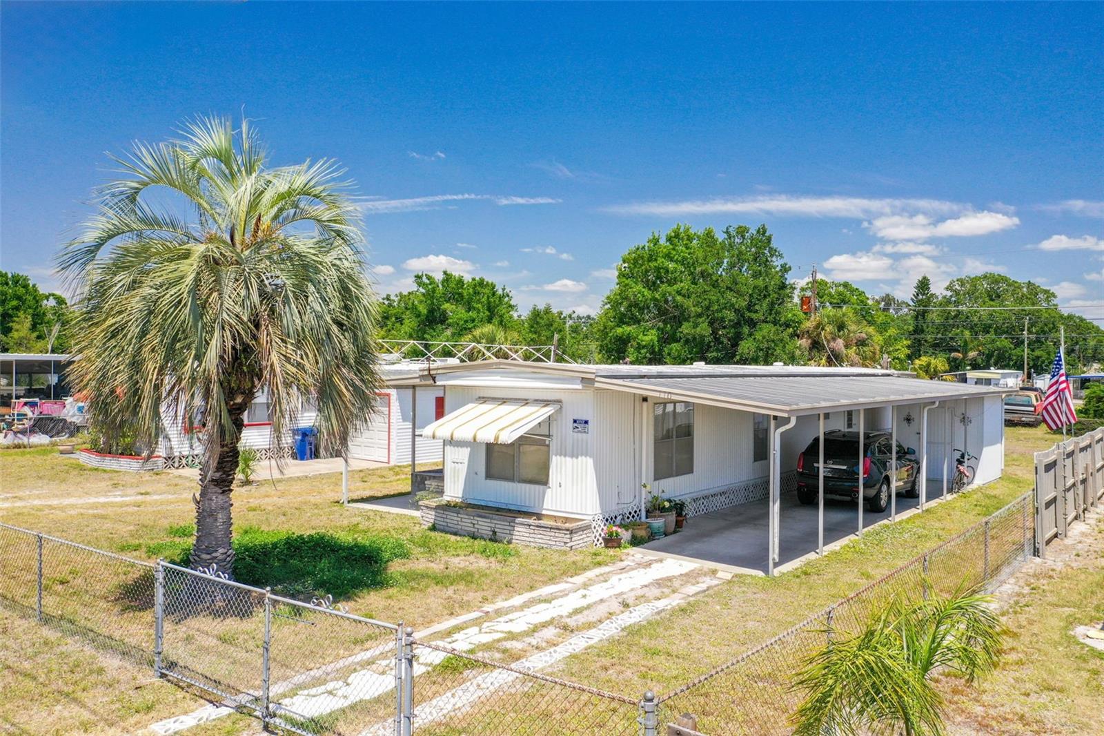 Located in the heart of coastal Nokomis, this 2 bedroom, 1 bathroom single-wide mobile home presents a rare chance to secure a property with strong investment potential in one of Southwest Florida’s most desirable areas. Just minutes from Venice Beach, Sharky's on the Pier, and Historic Downtown Venice, this property offers an ideal setting for a seasonal retreat, rental income, or future redevelopment. The home has been well-maintained and offers a functional layout, with an open kitchen and living area, two bedrooms, and a full bathroom. The covered carport area includes a dedicated laundry closet, adding practicality and additional storage space. The carport also provides covered parking and outdoor enjoyment. The lot offers ample room for outdoor activities or future expansion, with no association fees or deed restrictions, allowing for renovation, rebuilding, or rental opportunities. Whether you are looking to create your coastal retreat or a rental property, this location provides the perfect setting to maximize its potential. This location is ideal for those who want to enjoy the charm and convenience of the Gulf Coast lifestyle. You’re a short drive to Venice Beach and the lively Historic Downtown Venice filled with dining, boutique shopping, farmers markets, and cultural events. Wellen Park and CoolToday Park are also nearby, offering year-round activities, spring training baseball, and new shopping and waterfront dining destinations. Additionally, Lot 108 (MLS #A4649831) is available for separate purchase or can be bundled with this property as a packaged investment opportunity. This offers an excellent chance to expand your investment footprint or create two income-producing properties just moments from the Gulf Coast.