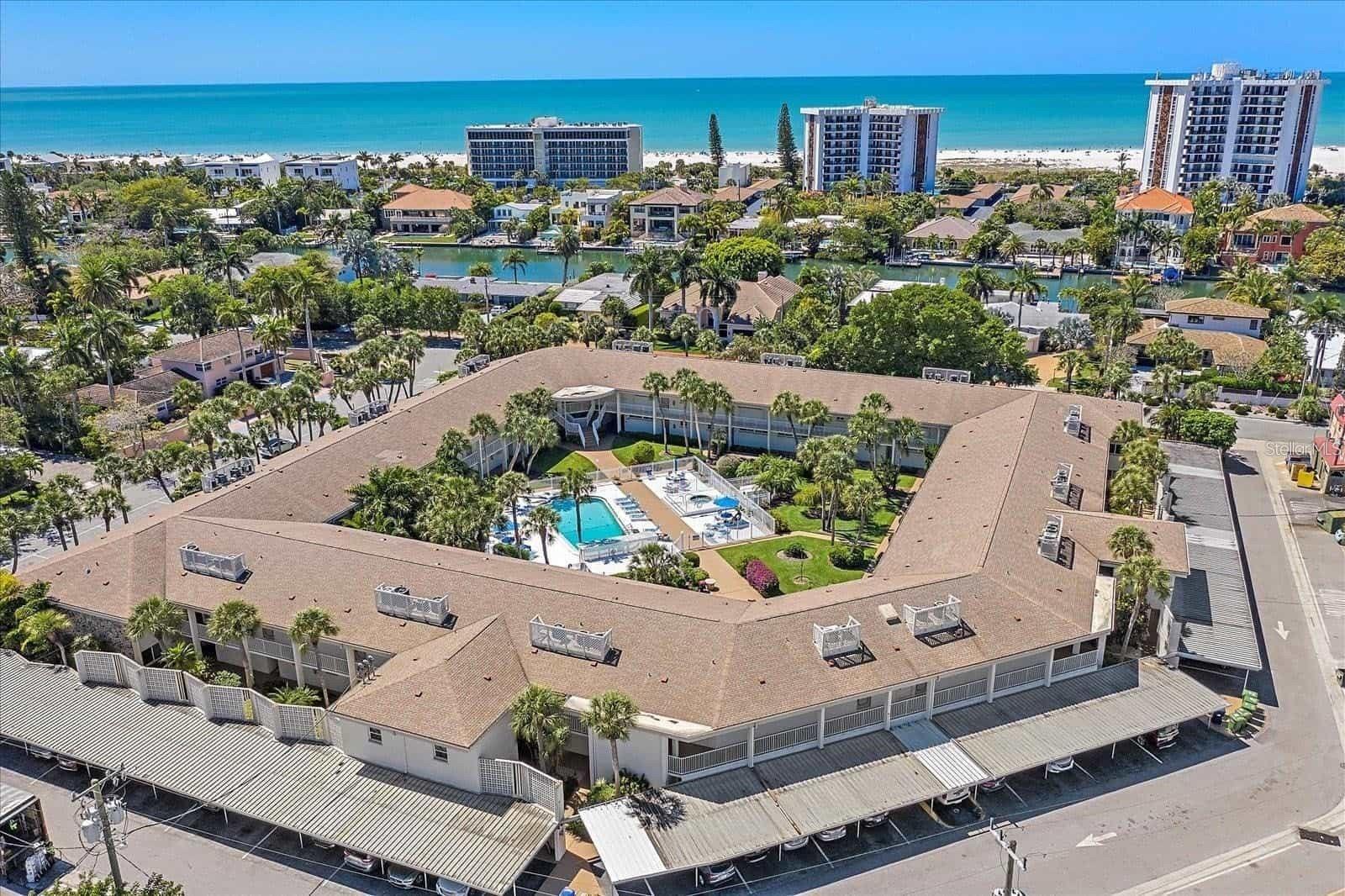 LIDO KEY DREAM VACATION RENTAL ! OPEN FOR 2026 SEASON, UPDATED AND WASHER/DRYER IN UNIT! Located just off Historic St. Armands Circle, walk to all the fabulous shops, award winning restaurants and most importantly, THE BEACH! You will love this fabulous location and this wonderful complex, this newly remodeled , including an in unit WASHER AND DRYER, two beds, two bath condo is located on the second floor (there is an elevator) and faces a quiet residential street. There is a King bed in the primary bedroom and a Queen in the second bedroom, they are both ensuite, the fully equipped kitchen has everything you need. Hang out by the heated pool and spa or spend the day at beautiful Lido Beach. You do have one covered parking space but there really is no need for a car, should you desire to explore, take the BayRunner Trolley and spend the day downtown or parts beyond. For the adventurous types, book a private kayak tour of the Mangrove Tunnels at Ted Sperling Park or book a kayak for the day.