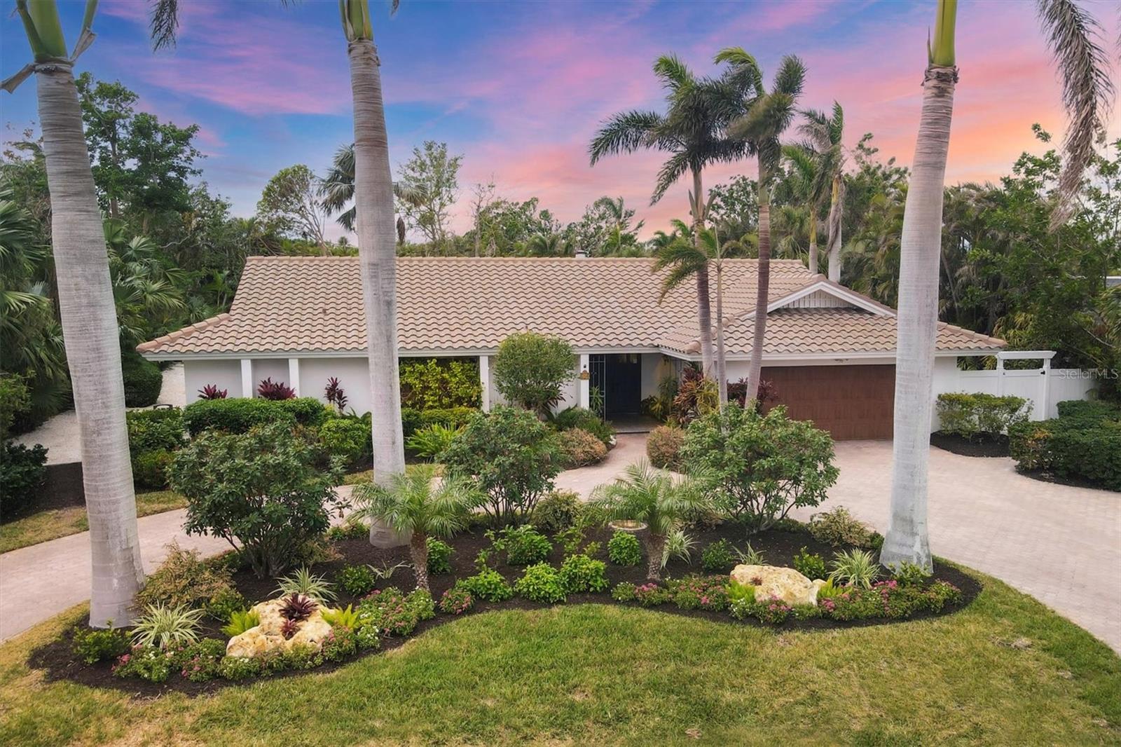 Welcome to this meticulously maintained home on the highly sought-after Bird Key, located on one of its most desirable streets. This 3-bedroom, 3-bathroom residence offers a thoughtfully designed split floor plan with a dedicated laundry room.
Impact-resistant sliders along the back of the home allow for seamless indoor-outdoor living and offer beautiful views of the tranquil garden. Wood-look tile throughout most of the home lends a sleek, modern aesthetic, while wood floors in the guest bedrooms add warmth and charm.
Upon entering, you’ll be greeted by an open foyer leading into the spacious sitting and dining areas. A wall of impact sliders allows the beautiful pool and garden area to be admired and provides excellent natural light. The kitchen features upgraded quartz countertops, a large center island, a gas cooktop, and a dual convection oven/microwave. A separate convection oven, microwave, and wine fridge make this kitchen perfect for entertaining and hosting parties. The additional windows and sliders off the kitchen fill the space with natural light and easy access to the covered area around the pool, which is also an ideal location for dining al fresco. At the end of the kitchen is a bright sunroom with walls of sliders open to a gazebo trellis and an outdoor patio with a gas grill and a private seating area.
The two guest bedrooms on the opposite side of the home offer peaceful garden views and plenty of privacy. One of the guest rooms features a built-in Murphy bed and desk, offering both function and flexibility. The primary suite is a true retreat, with custom shelving framing the entry and a large walk-in closet. The en-suite bathroom includes a separate tub and shower, and the bedroom has sliders leading out to the patio and pool area.
The lush backyard is a private oasis featuring a sparkling pool surrounded by tropical foliage. The spacious covered area is perfect for both relaxing and entertaining, with ample room for seating and a dining table. Additional highlights include a new tile roof (2022), New impact-resistant sliders throughout, a private irrigation well, an epoxy-coated garage floor, and electric blinds.
Another exceptional feature of Bird Key is the Bird Key Yacht Club, which offers an optional membership with exclusive access to top-tier amenities, including tennis courts, a refreshing swimming pool, a fully equipped fitness center, a vibrant social atmosphere, boat slips, a marina, and both indoor and outdoor dining options. This home is ideally located at the front of Bird Key and is just a short walk to the Bird Key Waterfront Park, St. Armands Circle, with its renowned shopping and dining and minutes from the white sand beaches of Lido Key. The iconic Ringling Bridge offers breathtaking water views and is a favorite spot for walkers. Downtown Sarasota, with its vibrant dining, shopping, and cultural scene, is just a short drive or walk away. Sarasota is known for its top-rated schools, world-class cultural programs, pristine beaches, and excellent medical care.
Don’t miss the opportunity to claim your slice of paradise—schedule a private showing today!