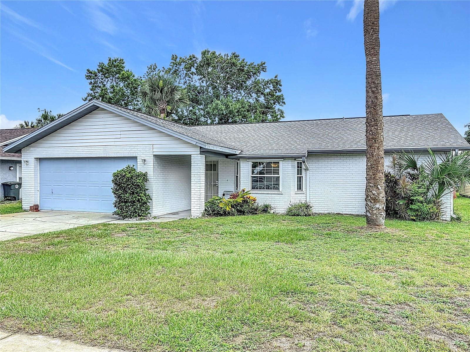 This is your opportunity to own a newly resurfaced pool home just 5 miles from Daytona Beach.
Completely renovated with hurricane coverage, new windows, roof 2016, new AC and brand new beautiful fence for the ultimate privacy.
Step inside this beautifully renovated pool home with high ceilings and huge a kitchen. Split floor plan with primary bedroom on the opposite side of the house for maximum privacy. Walk-in closet with built in shelves for great storage and organization. Primary bathroom has a walk-in shower and single single vanity with sleek style and classic materials. 2 bedrooms and 1 bathroom on the opposite side of the house with large closets and plenty of storage space. From the living room the french doors will lead you to the covered patio which is perfect all year round. Refreshing kidney shaped pool recently resurfaced in 2024. This home has a 2 car garage with ample space for your cars or golf cart. Washer and dryer are located inside the garage