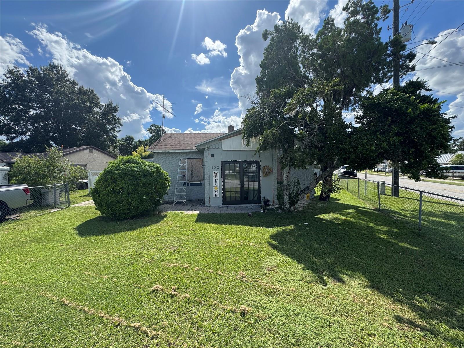 Charming Corner-Lot Fixer-Upper with Endless Potential. Welcome to 102 Orange Ave, located on the corner of Orange Avenue and Camellia Drive in Winter Haven. This northeast-facing property sits on an east-facing corner lot, fully fenced with chain link for privacy. Though it’s definitely a fixer-upper in need of some TLC, this home offers a brick-paved entryway with a charming dual door and a brick-paved sidewalk. You'll find a detached two-car garage at the back of the property, offering additional storage space and plenty of room for your tools or hobbies. This is an as-is sale, making it a fantastic opportunity for investors looking to flip or for anyone who wants a project with lots of potential. Homes on corner lots with this much versatility are a rare find. Don’t miss out on the chance to transform this property into your next great investment or personal project!