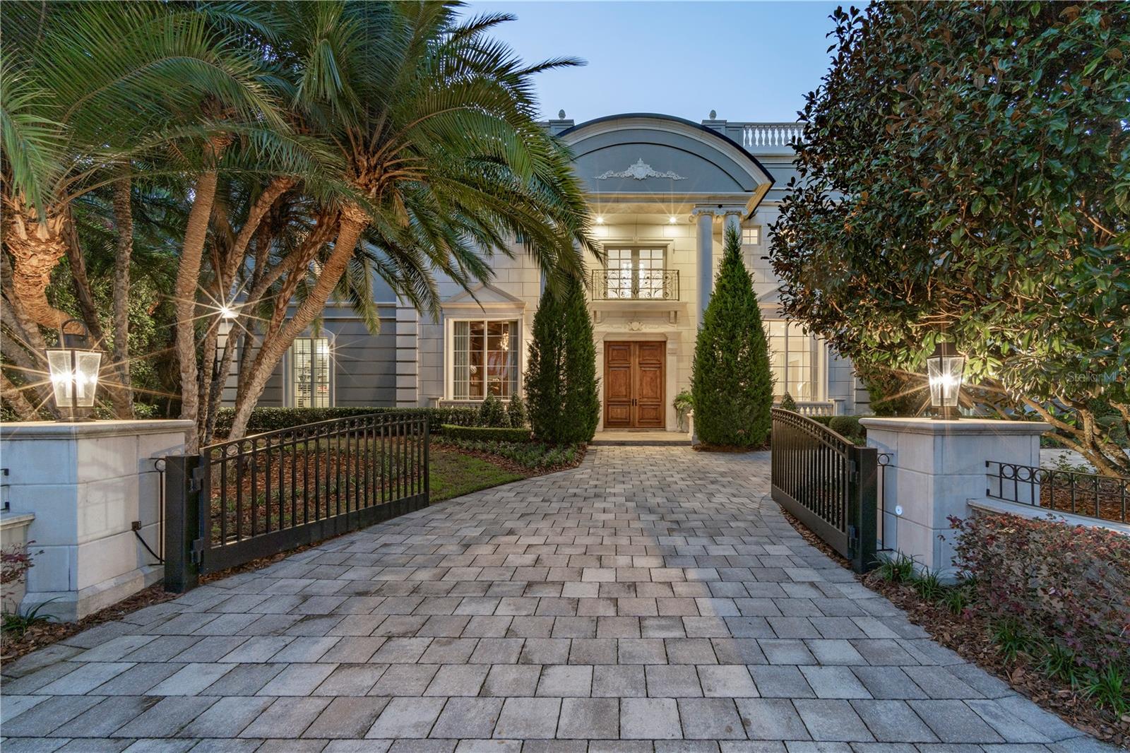 Elegant French Mediterranean gated lakefront estate on premier exclusive and private setting in Olde Winter Park… Extremely RARE opportunity to purchase a spectacular residence located on the Isle of Sicily (only 11 homes on this exclusive island) with dramatic water views on both sides of the property to enjoy sunrises and sunsets across Lake Maitland (largest lake on the 6-lake chain of lakes). This property is a one owner custom built home resting on approximately 3/4 acre upland (1.41 total acres per tax records) of property secluded on a private island off the Via’s neighborhood inclusive of the Winter Park Racquet Club walking/boating distance away… This custom-built residence was completed only 9 years ago with wonderful bright-open floor plan and flooded with light from extensive walls of glass… The interiors are not only light, but sleek, modern, and tastefully decorated with gorgeous lighting, extensive moldings and top-quality craftsmanship that will captivate you from the moment you enter the grand foyer looking straight through the 2-story living room to breathtaking views of the pool, grounds & lake... Additionally, downstairs you will enjoy a private library, formal (but open) dining room, fabulous chef’s island kitchen with Sub-Zero, Thermador Italian ILVE appliances including a casual dining area open to the lakeside gathering room with masonry fireplace, plus wine room along with the lavish primary owner’s quarters including a “Four Seasons” spa-like bath & his/her dressing areas, bar with refrigerator, fireplace & steam room… Upstairs commences with a stunning winding stairwell of glass panels taking you up to an expansive, open lounge area with curved corner bar and separate billiards are all open to the lakefront terrace… Plus, 3 flexible rooms: currently utilized as a media room, massage room, and exercise room… As well as a junior oversized guest suite and three more bedrooms all with private en-suite baths… The outdoor lakefront living includes majestic Cypress trees, expansive covered lanai, summer kitchen, tropical heated salt pool and spa with beach entry, fiberoptic lighting, fire bowls & fountain, a dedicated fire pit seating area, complete boathouse & more… Other notable features include an elevator, 5 masonry fireplaces, 2 separate laundry rooms up/down, 2 dishwashers, butler’s pantry, wine room, Control4 home automation, 4 zoned AC systems, termite bond, lake irrigation, dedicated outdoor pool bath, “oversized 4-car garage”, automatic gated circular drive entry, & more…