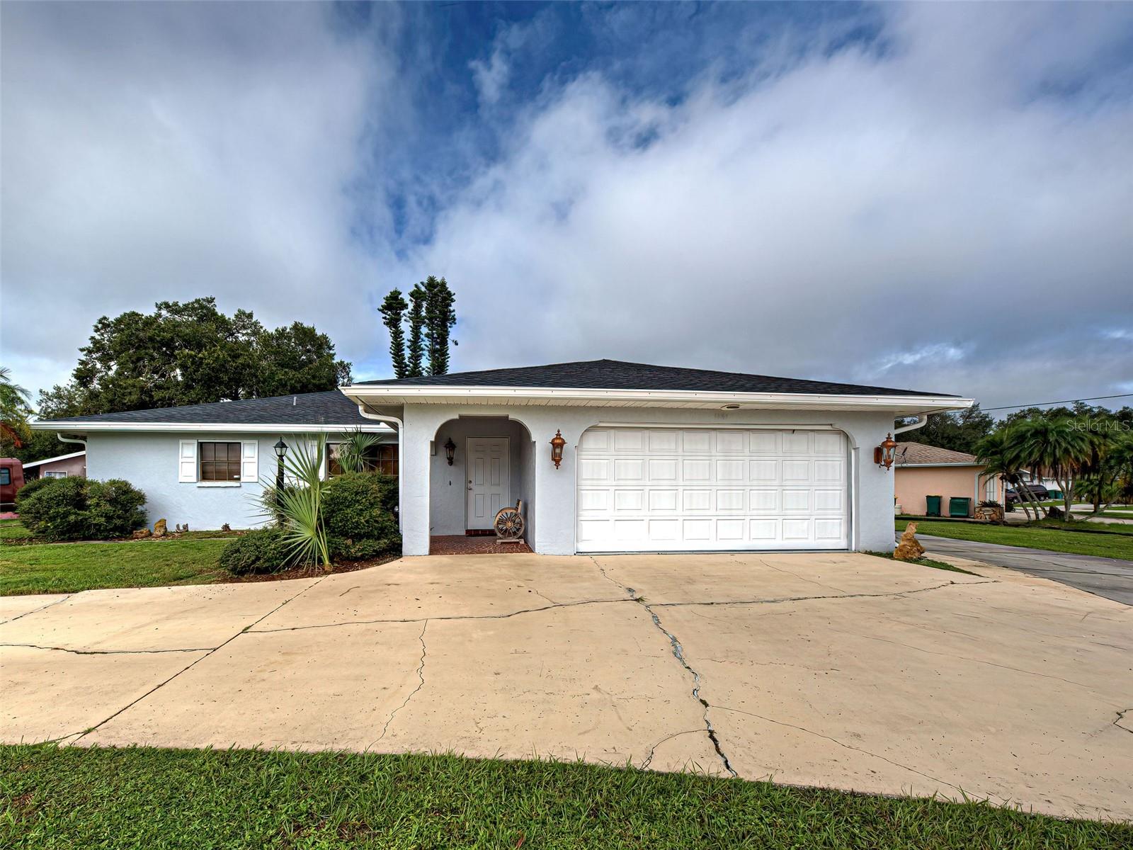 One or more photo(s) has been virtually staged. NEW ROOF, NEW PAINT OUTSIDE and inside. Cathedral ceilings, ceiling fans, adt alarm system installed and ready to be activated. NEWER ELECTRICAL BOX! NEWER PLUMBING under all of the sinks in the bathrooms and the kitchen. No HOA fees. NO CDD fees. RAIN GUTTERS, and 4 POINT INSPECTION INCLUDED. This house is spacious with a SPLIT FLOOR PLAN. This corner lot is 14,788 sq feet and spacious. You have plenty of room to park a Boat or and RV. BRING ALL OF YOUR TOYS! The home has a 2 car garage with plenty of storage space. Hurricane shutters INCLUDED! This is a ranch style home with plenty of space for all of your social gatherings too. This home has every thing you need to make this house your home. The kitchen has a great L shape. The countertops are a granite, stone tile. The backsplash matches nicely with the natural stone . This kitchen has a lot of cabinets and the appliances are all matching in color. The kitchen is spacious and the flow makes cooking easy. The kitchen includes the stove, refrigerator, microwave and a dishwasher. The inside utility room is directly located across from the kitchen, NOT IN THE GARAGE. The utility room is under air and makes doing laundry easier and convenient. Lastly, the home has an enclosed lanai too! The location of this home is perfect. It is close to shopping and the many restaurant's that Port Charlotte has to offer. Don't delay. Call for your reserved tour today.