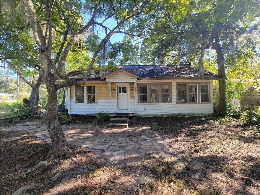 Discover the charm of “Old Florida” living with this unique opportunity in historic Cross Creek. This 3-bedroom, 2-bath home sits on a double lot along a canal leading to Orange Lake, surrounded by majestic oaks, cypress, and draping Spanish moss swaying in the lake breeze.
Located just off County Road 325, next to Marjorie Kinnan Rawlings State Park, you’ll enjoy easy access to the park’s boat ramp, picnic pavilions, and playground. Nature lovers will delight in the abundant wildlife—hawks, ospreys, and eagles frequently soar overhead—and anglers will appreciate the excellent fishing for largemouth bass, bluegill, and redear sunfish on the beautiful lake.
There’s plenty of space to park your boat or RV, or even add another structure if desired. The property is less than a mile from the famous Yearling Restaurant and less than a half hour drive to Gainesville or Ocala, offering both seclusion and convenience.
This home is ready for someone with vision—bring your renovation skills and restore this lakeside retreat to its former glory. Whether you’re looking to establish a full-time residence, weekend getaway, or seasonal escape, the potential here is endless.