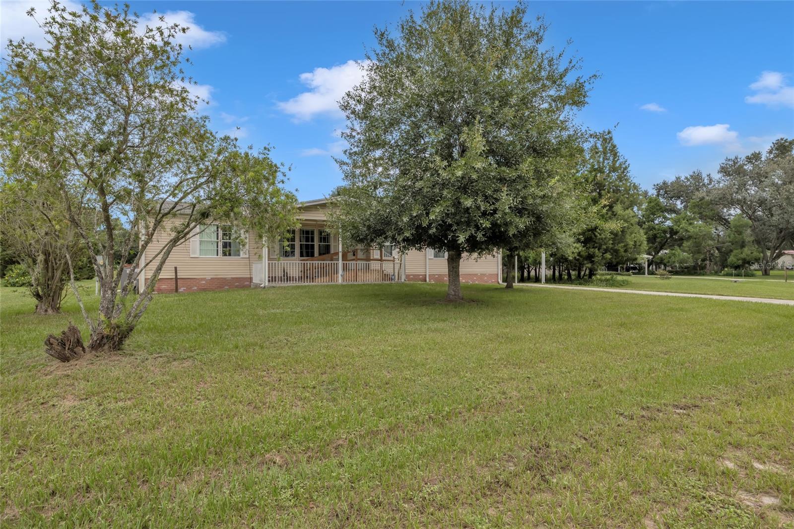 Welcome to a charming 4-bedroom, 2-bathroom manufactured home built in 2003, offering both comfort and functionality in the heart of Wesley Chapel. Thoughtfully designed for everyday living, this home combines spacious interiors with practical upgrades and accessibility features.
Step inside to find an inviting floor plan with ample natural light and room for the whole family. The kitchen is well-equipped with plenty of cabinet space and flows seamlessly into the dining and living areas — perfect for gatherings and entertaining. The primary suite includes its own private bath, while the additional bedrooms that has flexibility for family, guests, or a home office.
Outdoors, enjoy the convenience of a tall attached carport, providing excellent coverage for vehicles, boats, or RVs. A welcoming front porch with wheelchair accessibility ensures comfort and ease of entry for all. The property also includes a detached storage building complete with air conditioning and electricity, ideal for a workshop, hobby space, or climate-controlled storage.
Nestled in a quiet setting yet close to shopping, dining, schools, and major roadways, this home provides the perfect balance of peaceful living and everyday convenience.
Don’t miss your chance to make this Wesley Chapel property your own — schedule a private tour today!