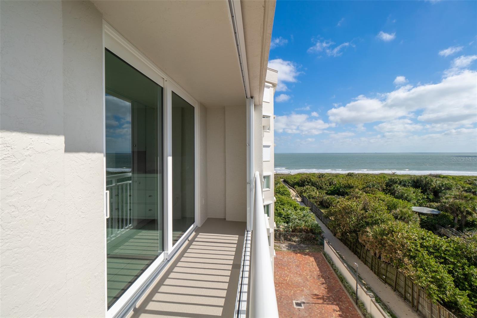 This stunning 3 bedroom, 2 bathroom condo at Emerald Seas offers the ultimate in coastal living with breathtaking direct ocean views from the living room, bedroom, & kitchen. You'll also experience spectacular Western views of the river, port, and rocket launches. The condo has been thoughtfully updated, with new sliding glass doors, a stylish modern kitchen with an abundance of cabinet space. Additional features include new storm shutters on the balcony and a storm door for peace of mind. Located in the heart of Cocoa Beach, you'll be in close proximity to the famous Ron Jon Surf Shop, local restaurants, and all the best attractions this vibrant beach town has to offer. Emerald Seas offers a gated community with excellent amenities, including a heated community pool and spa, private beach access, fitness center, tennis & pickleball courts, and a car wash area. Under building garage parking space # 88 includes a large personal storage cabinet for beach items and more.