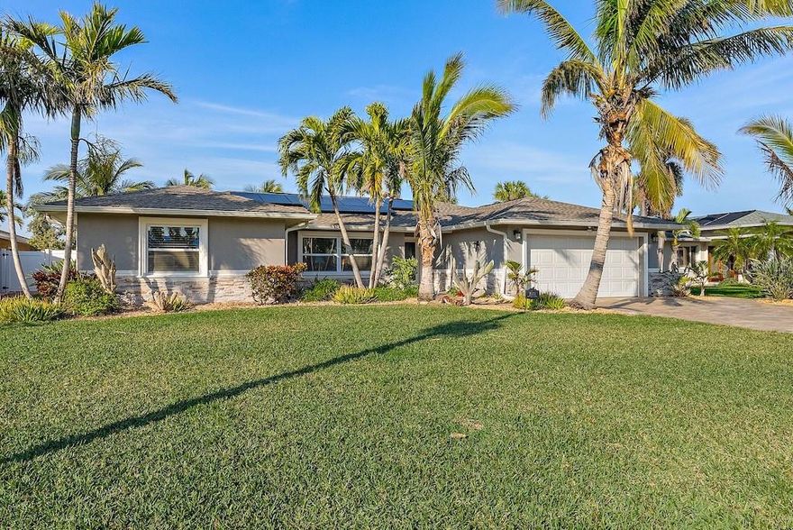 Where coastal Refinement and  Modern luxury — welcome to this EXQUISITE 3-bed, 2-bath WATERFRONT retreat in YACHT CLUB ESTATES, one of St. Pete’s most sought-after waterfront communities!   This House is Beautifully Maintained with  The OPEN-CONCEPT featuring a spacious living area with a CUSTOM Wood MEDIA WALL, 89” TV, surround sound, Custom Glass and Stainless Tile imported for Madrid, Italian Porcelain Floors throughout, ideal for relaxation, low Maintenance & Entertaining.  The beautifully appointed KITCHEN offers high-end Italian Luso cabinetry with quartz countertops, GE Profile Stainless Steel Appliances, Featuring  Double Convection ovens, Top of the line Dishwasher, Built in Refrigerator, Bread/Plate Warmer, NATURAL GAS COOKTOP, prep Sink Area, Huge modern island with storage and Separate Wine Area in the Dinning Area with 300 Bottle Built in Wine Cabinet. The primary suite offers stunning WATER & POOL VIEWS, a large walk-in closet, and a spa-like bathroom with a jetted soaking tub, Huge walk-in shower.   Two guest bedrooms share a renovated bathroom with Sub-way tile and custom Wood working, a walk-in glass-enclosed. Shower with imported Italian tile, while the third guest bedroom has access to the Pool area and views of the Water . This home boasts Alside Impact Windows throughout with the remaining 30 year Warranty from the manufacturer as well as Costal Rated Impact and Extremely water resistance PGT Vinyl sliding glass doors and 6 Bi-Fold Origin Coastal Rated Extremely water resistant Impact Doors offering uninterrupted views of the resort-style pool and the water, creating a seamless INDOOR-OUTDOOR LIVING experience. ROOF 2017 Timberline UHDZ 35-40 year, wind rated to 150mph  Manufacturer Specs, AC 2024 TRANE system. This house also features a Generac natural gas-20 KW Generator also this house is fully powered with  SOLAR Panels 2018-21 respectfully, wind rated to 125 MPH with output enough for an EV if desired, current Electric bill is $35 with a refund from Duke for excess yearly.  The outdoor space is an ENTERTAINER’S PARADISE, with a LARGE POOL surrounded by beautiful Pavers, EXTENDED BACKYARD features. covered OUTDOOR KITCHEN with Beautiful Custom Cypress Mill Work, an Ice Maker, Refrigerator, Stainless Steel Kitchen-Aide Built in Natural Gas Grill with expansive Quartz countertops. The FULLY FENCED, Beautifully landscaped Resort like yard offers low maintenance approach to outdoor living including underground rain ducts for removing roof water away from the foundation and paver areas with runoff valleys along the property to channel water away. 2 Coconut Palms at the end of the pool where the  Hammock hangs is perfect for relaxing to watch the Dolphins and Manatees playing out back or watch the beautiful Gulf Sunsets. Boating enthusiasts will appreciate the like new COMPOSIT DOCK and 14k pound Lift which provides direct access to the Intercoastal Waterway & Gulf of Mexico.  Situated close to beaches, shopping, and dining, YACHT CLUB ESTATES offers more than just a neighborhood it embodies the true Florida lifestyle. Owner’s Preparations and Quality Materials used in the renovation kept this house from suffering damage in either storm, there was some seepage that was dried immediately from the first storm and nothing from the second storm except some landscaping, which has already been replaced.. 2019 Colbalt 30sc with custom Painted twin 300HP Yamaha engines is also available for sale for 185K with only 147 Hours.